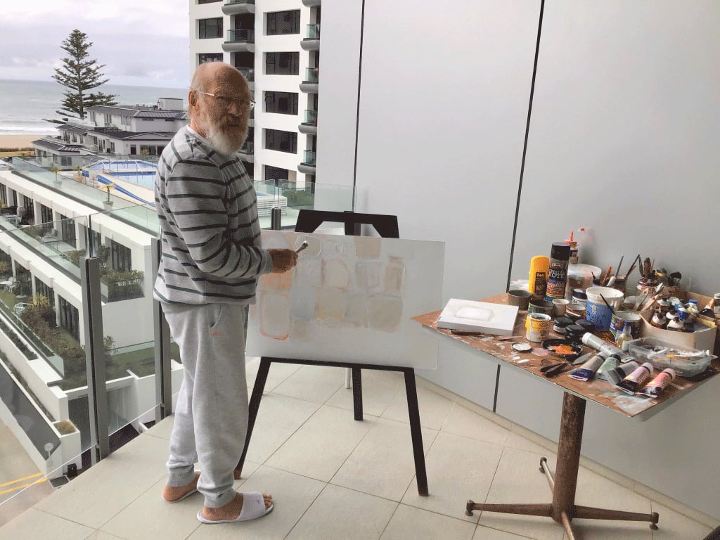 John Blackburn painting on his apartment balcony in Tauranga during lockdown