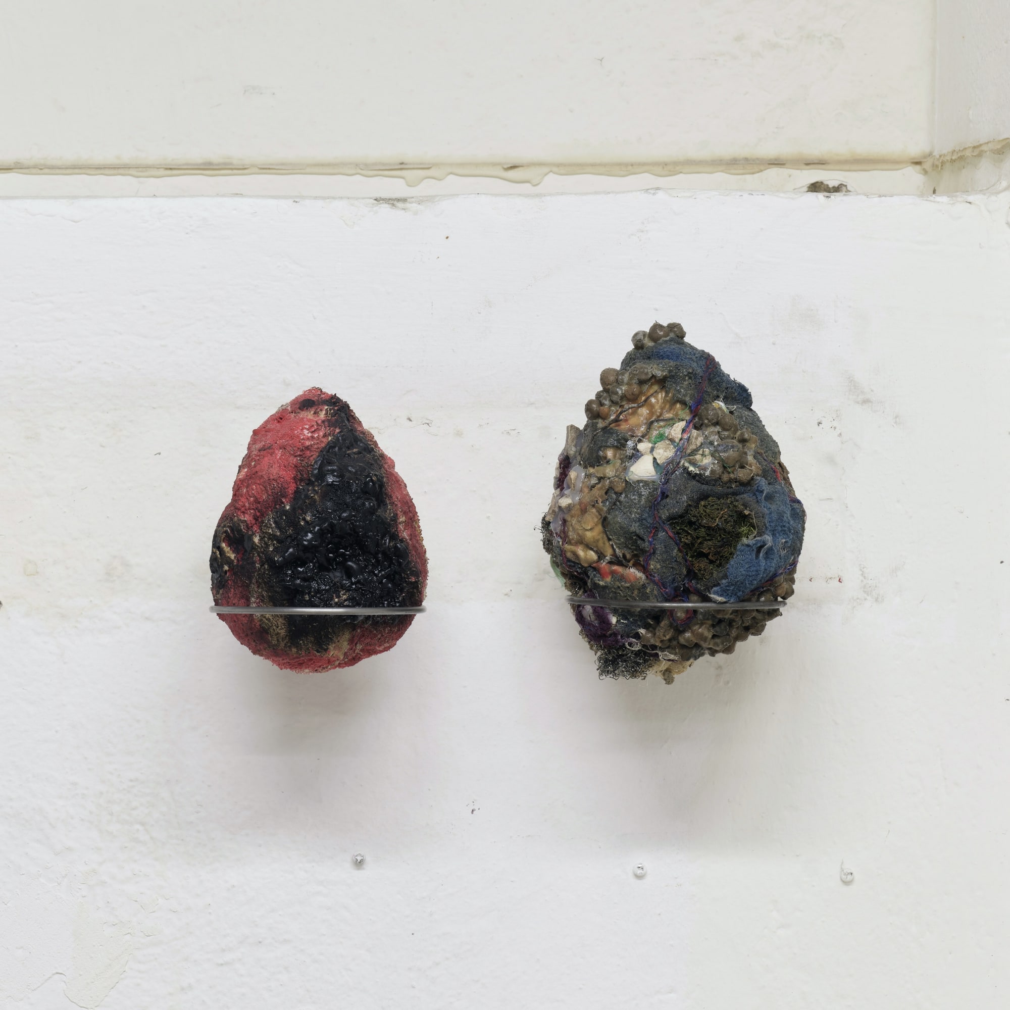 Left to right, Ovo por Olho (An Egg for an Eye), 2017-2023, latex, soil and textile debris, 17 x 13 x 13 cm; Ovo por Olho (An Egg for an Eye), 2017-2023, latex, soil and textile debris, 21 x 15 x 15 cm
