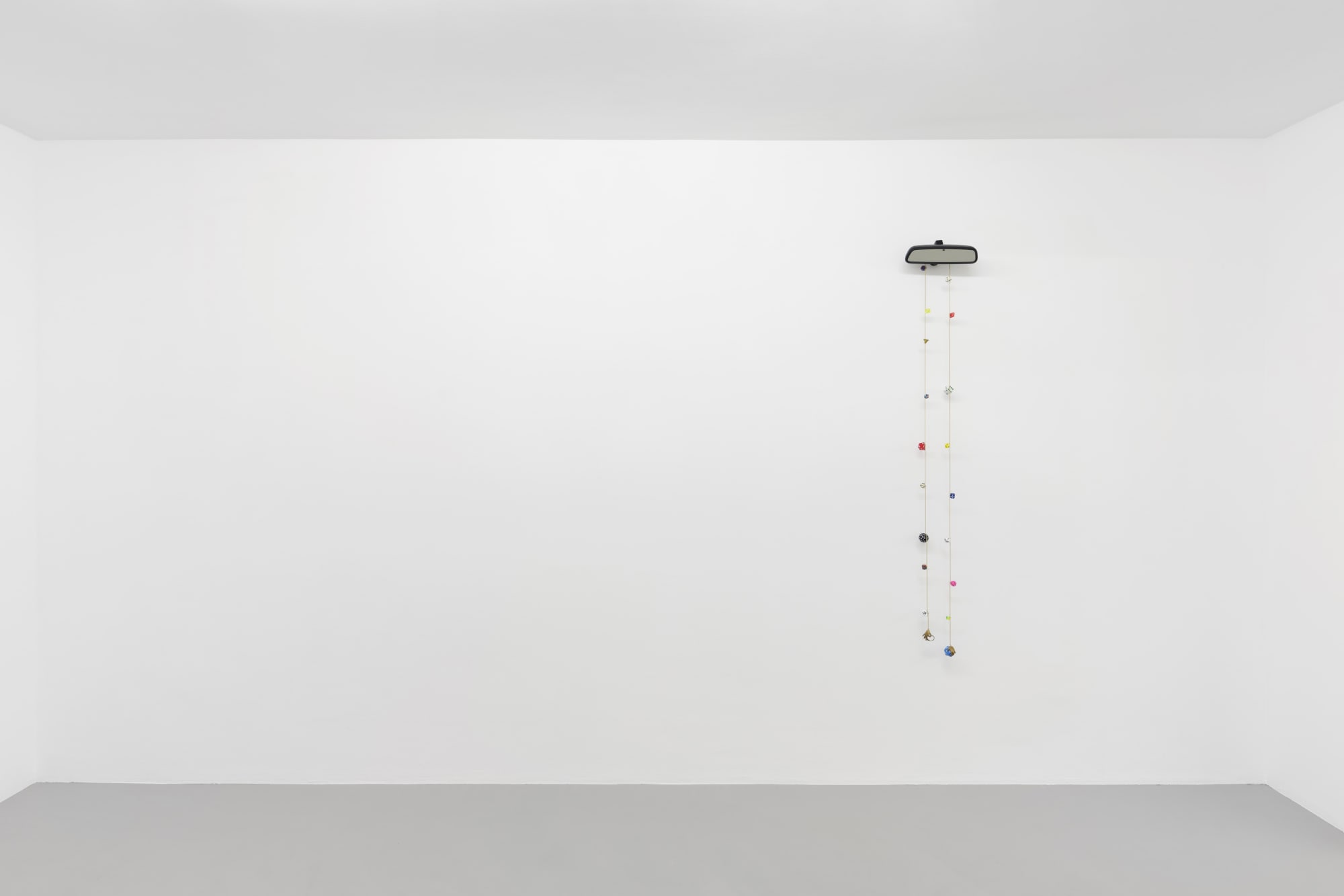 Cassidy Toner, Hindsight is 20/20 #3, 2020-2021, car mirror, dice, brass and chain, 160 x 24 x 6 cm