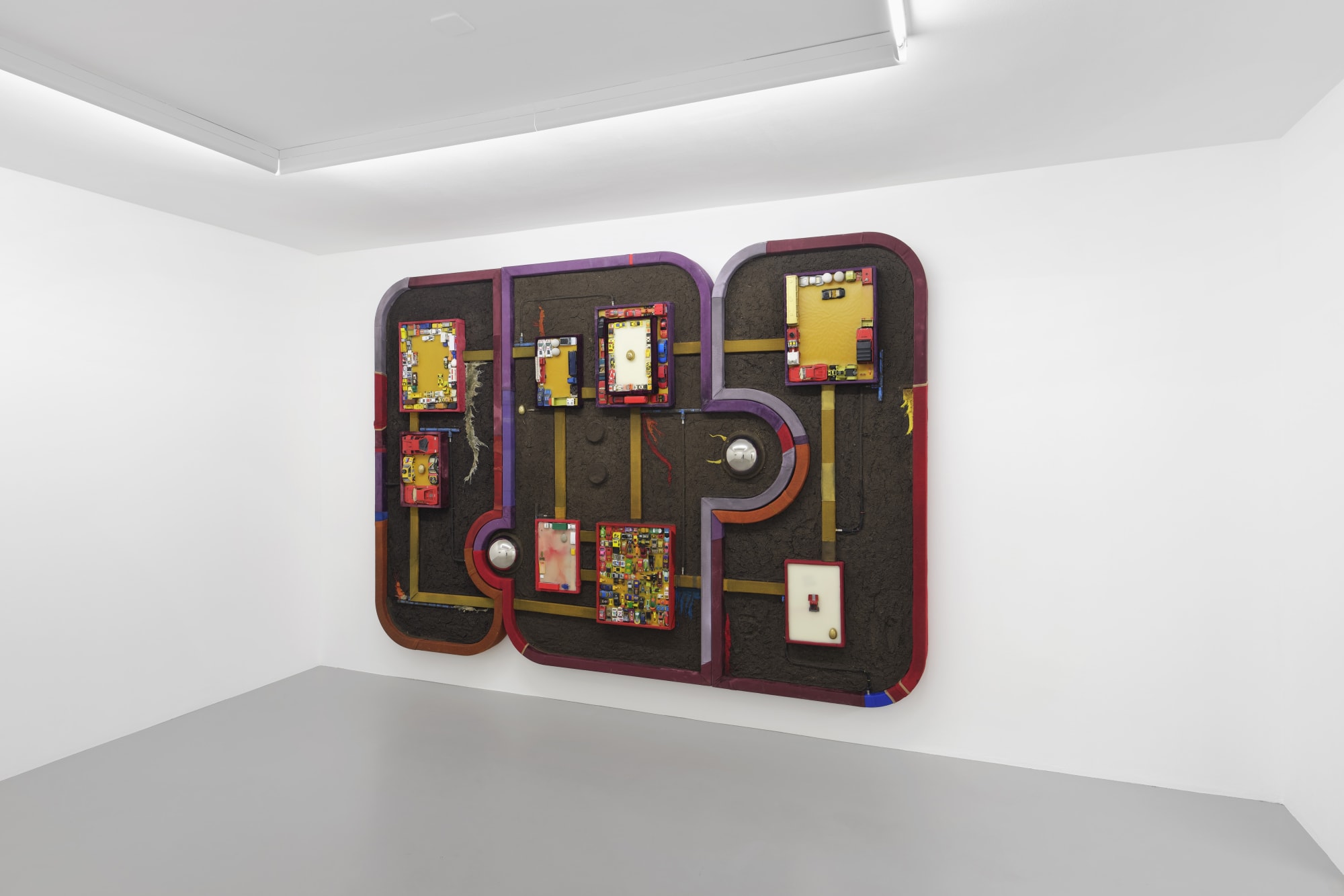 Soil’s Memory, 2020, beeswax, textile debris, concrete cast, bronze cast, plaster cast, iron cast, toys, acrylic on wood, 200 x 355 x 17 cm