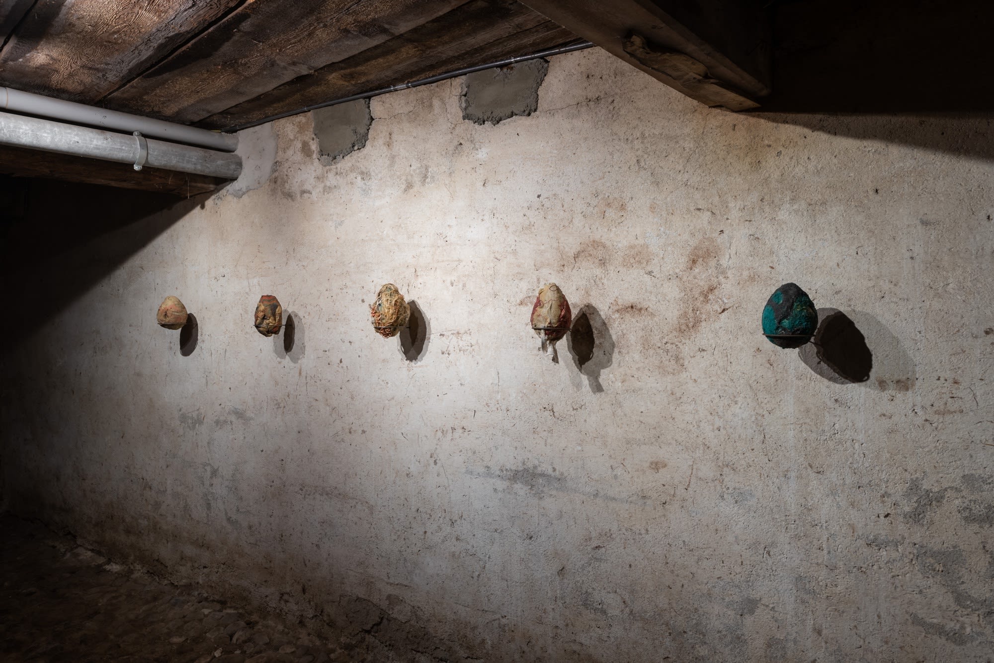 Installation view of five works, Ovo por Olho (An Egg for an Eye), 2017, latex, fabric, organic material, dimensions variable