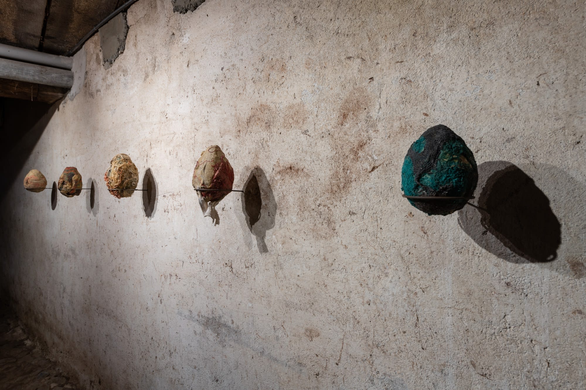 Installation view of five works, Ovo por Olho (An Egg for an Eye), 2017, latex, fabric, organic material, dimensions variable