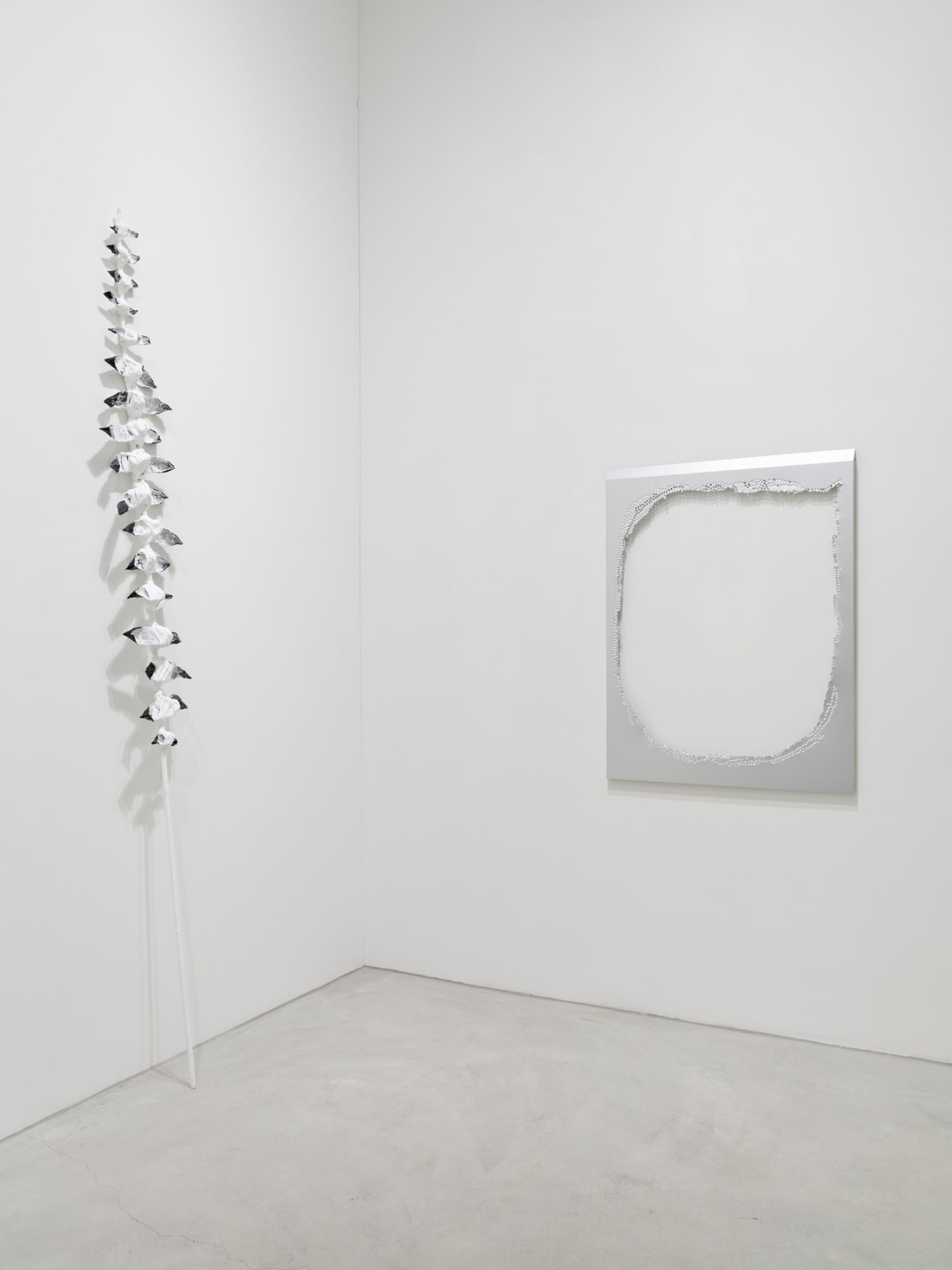 Left, Luxury Goods (Nr.1/ Fra Angelico’s Feather), 2025, bamboo, plaster, collagen, acrylic on tubes, 300 x 30 x 10 cm