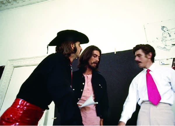 Color photograph of Ringo Starr and George Harrison in a studio setting
