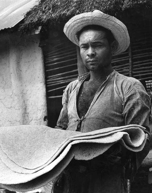 Black and white photograph of man holding cloth