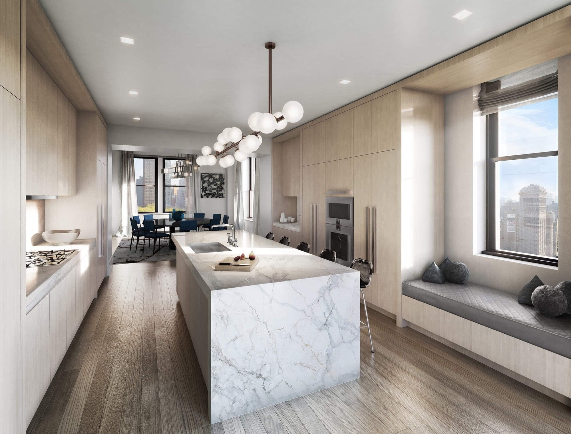 Interior view of a luxury kitchen with marble and light wood.
