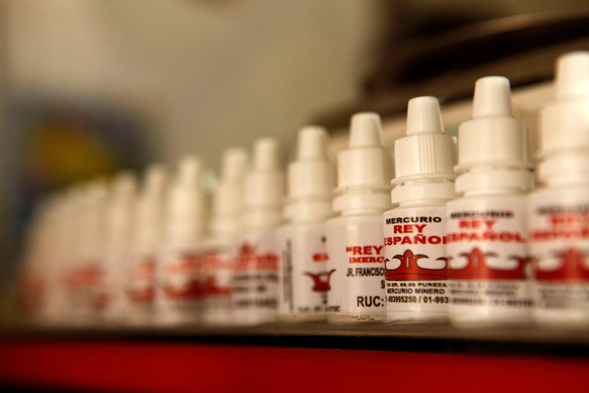 Numerous bottles of mercury lined up together on a shelf