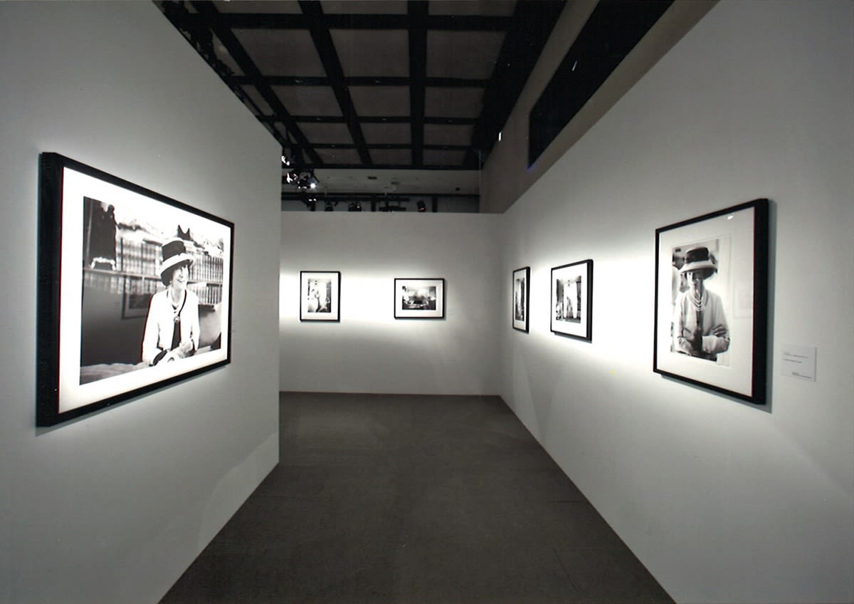 Installation view of the exhibition Coco Chanel, 1962: Photographs by Douglas Kirkland featuring several black and white photographs of Coco Chanel 