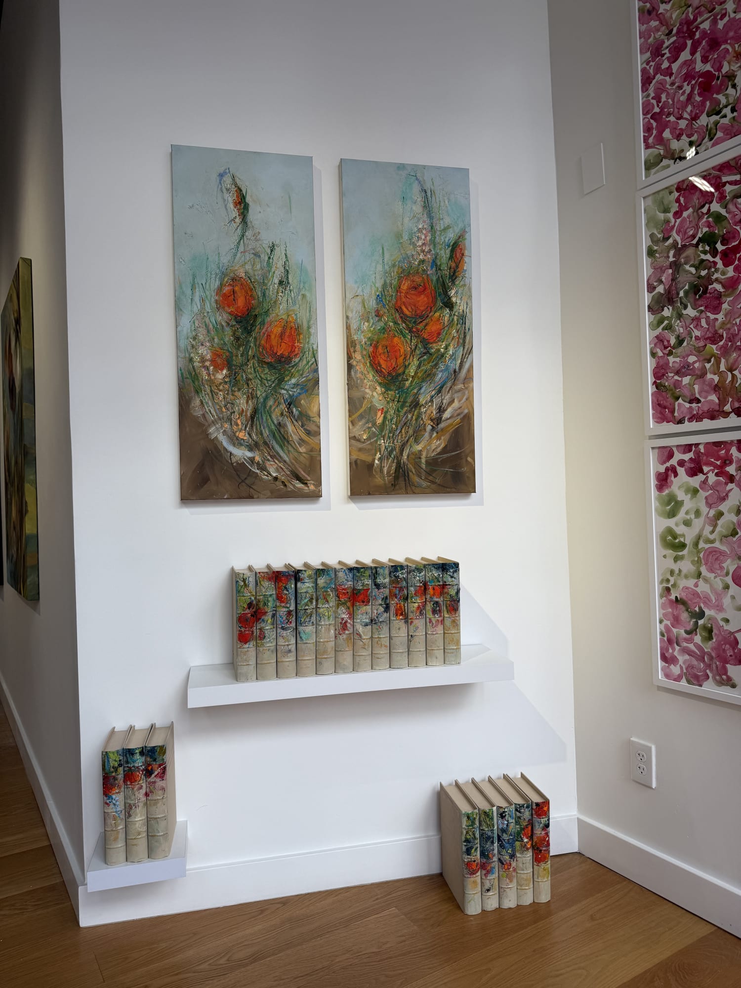 paintings of flowers in a gallery