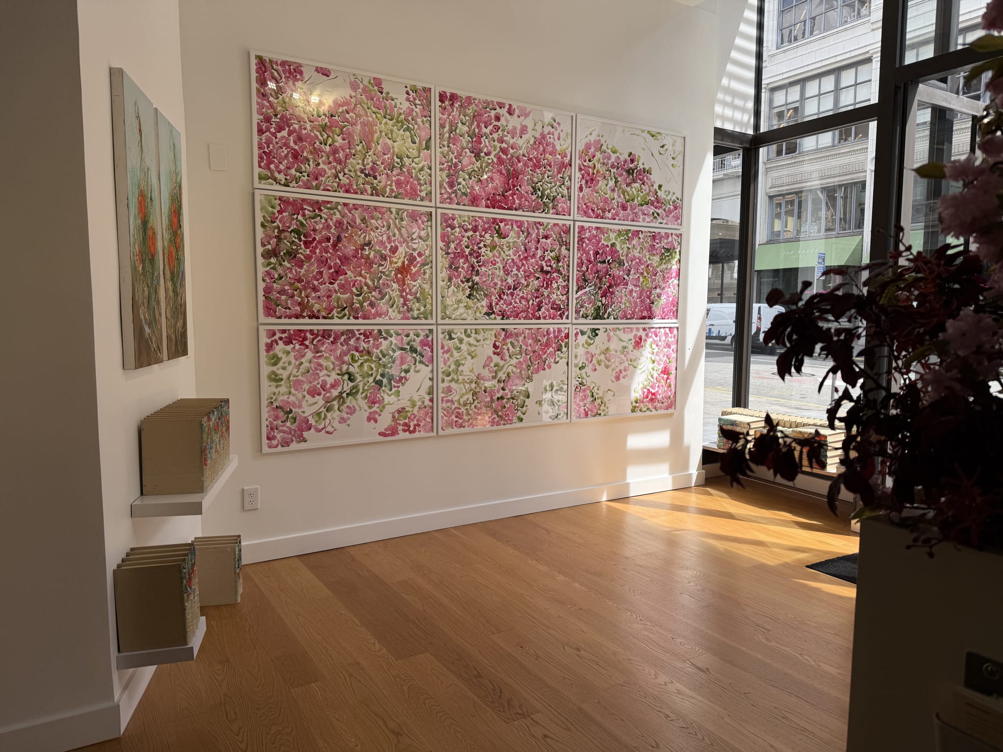 paintings of flowers in a gallery