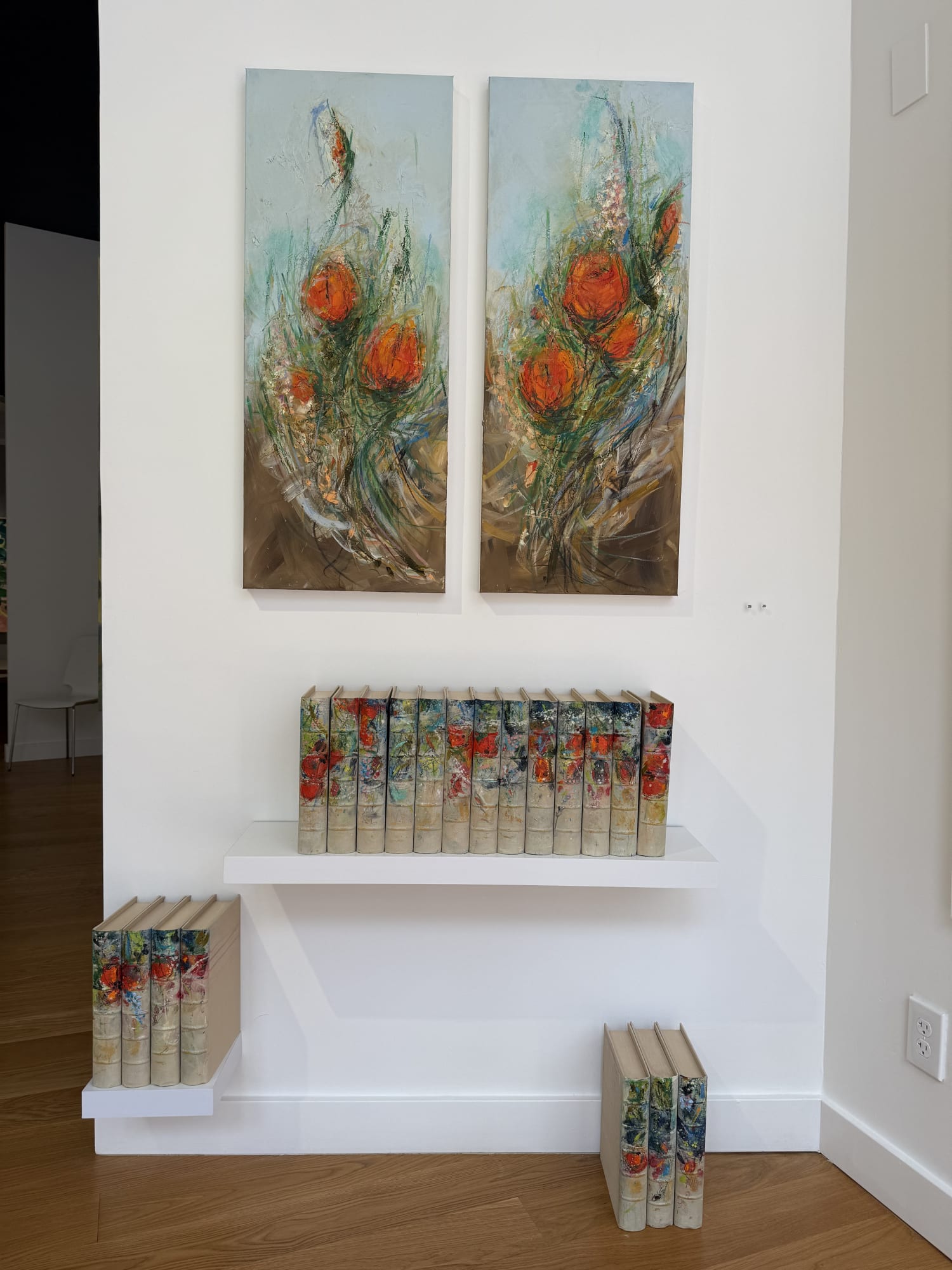 paintings of flowers in a gallery