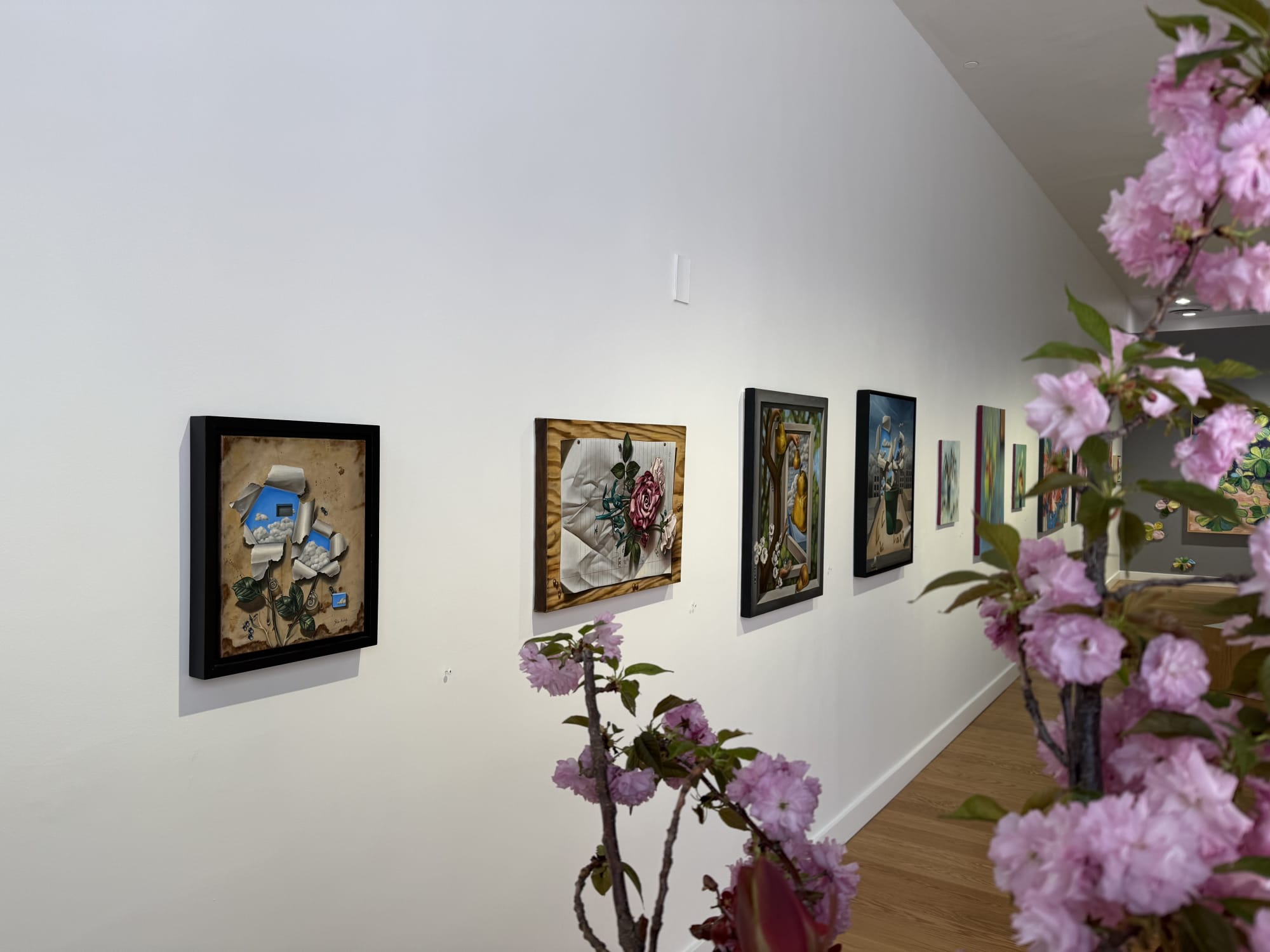 paintings of flowers in a gallery