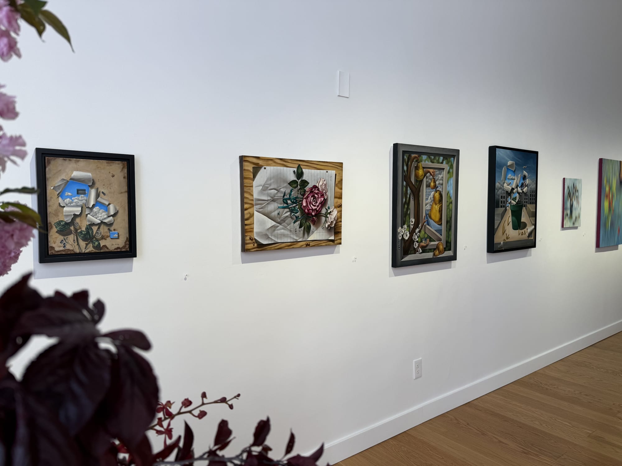 paintings of flowers in a gallery