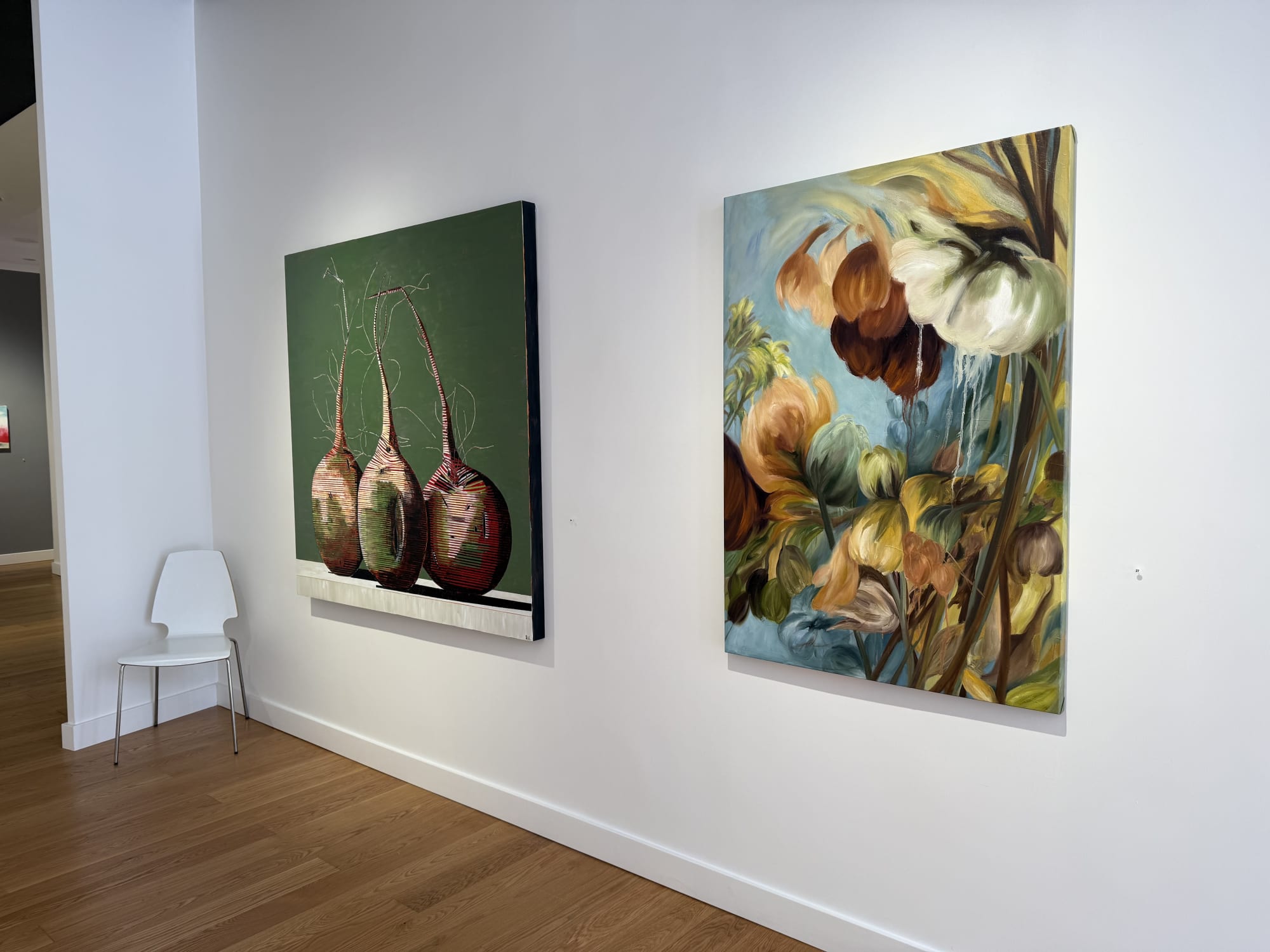 paintings of flowers in a gallery