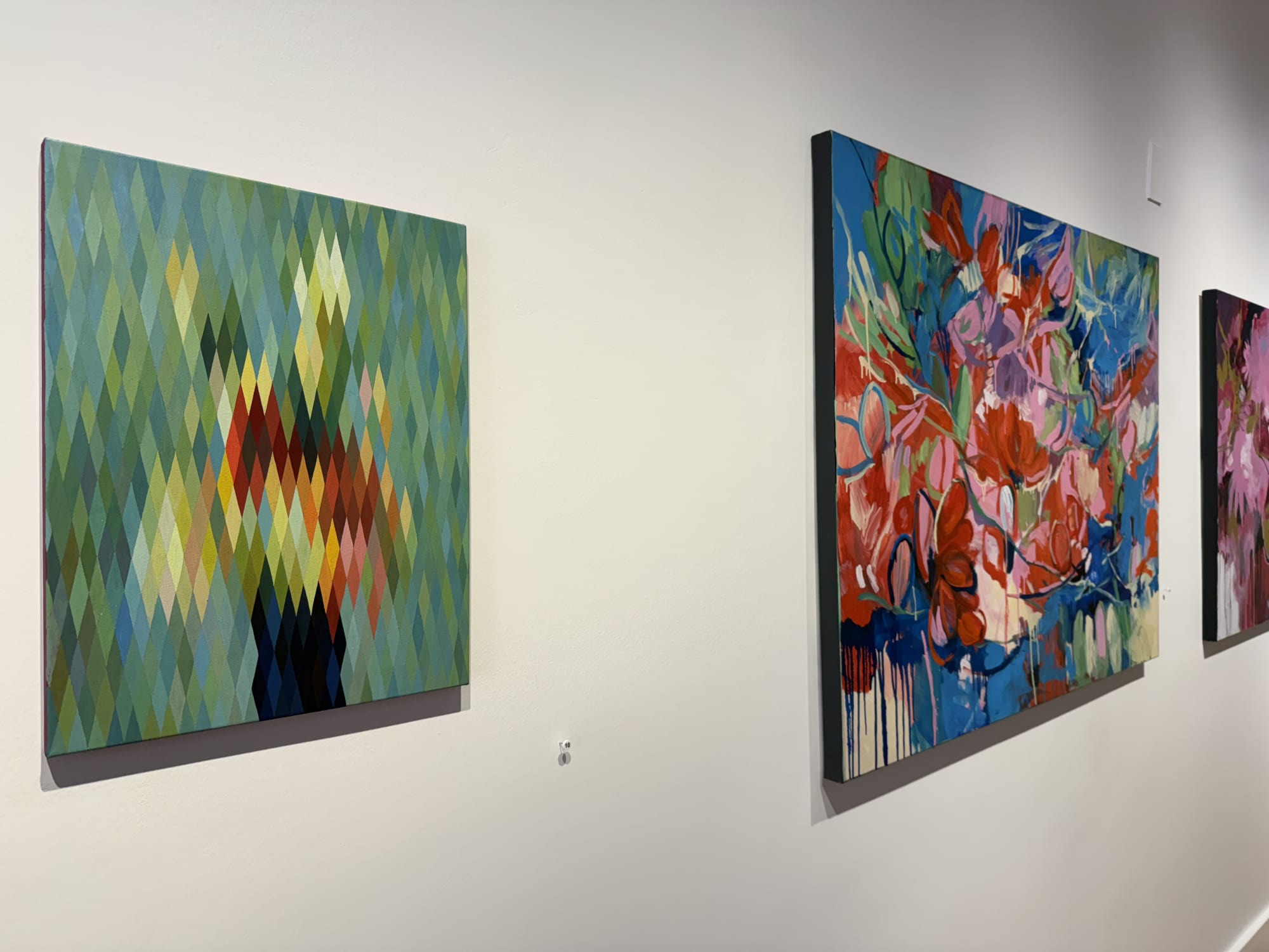 paintings of flowers in a gallery