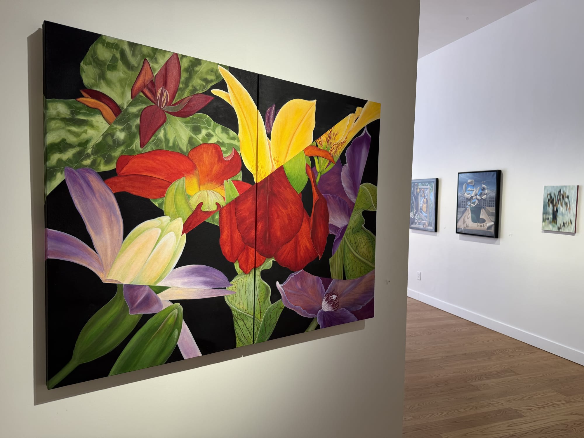 paintings of flowers in a gallery