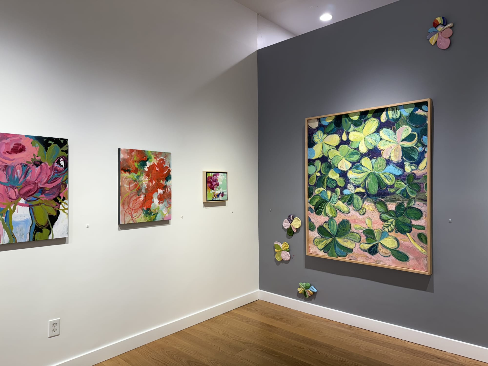 paintings of flowers in a gallery