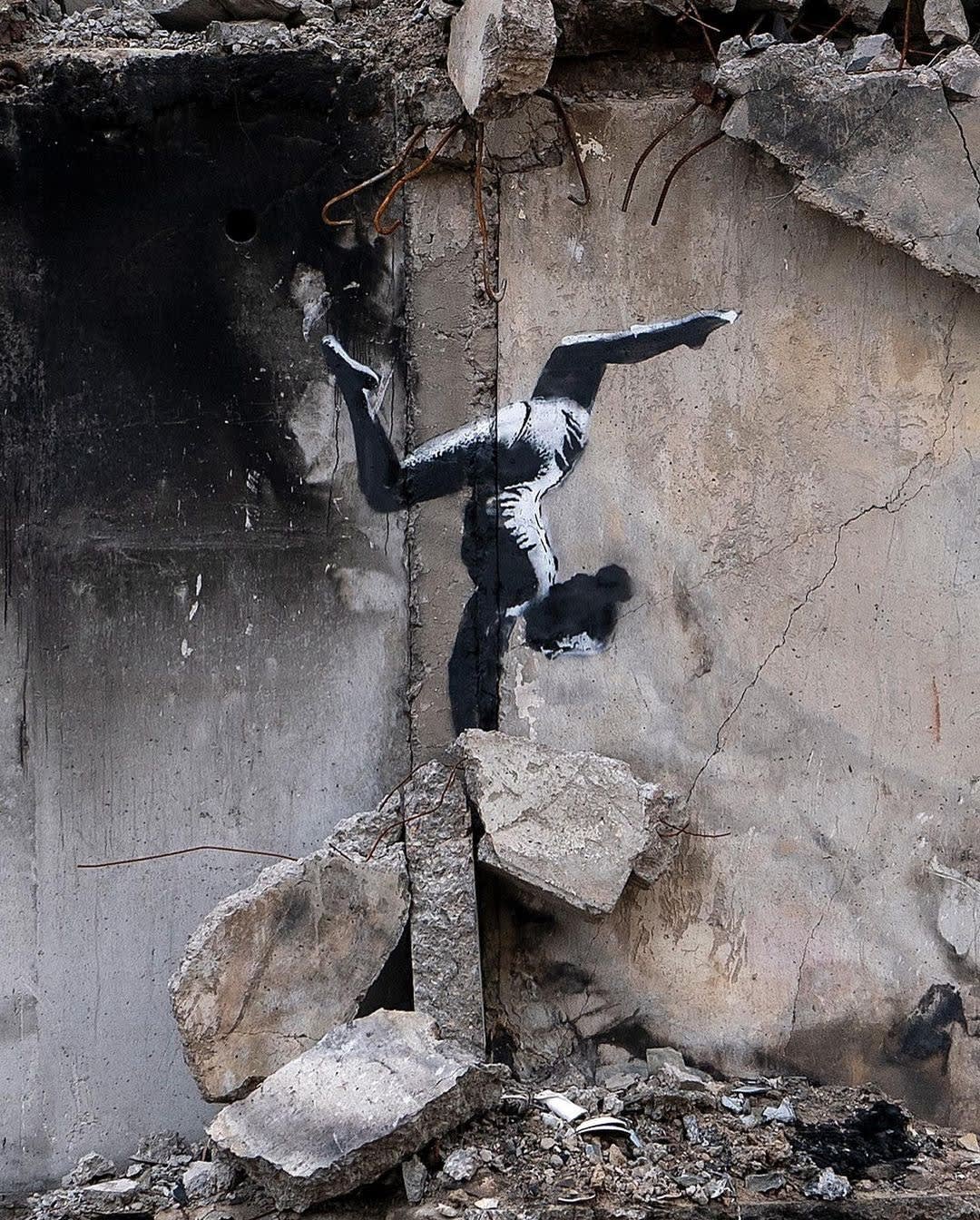 Banksy’s 2022 The Gymnast mural in Borodyanka shows young girl balancing, symbol of resilience.