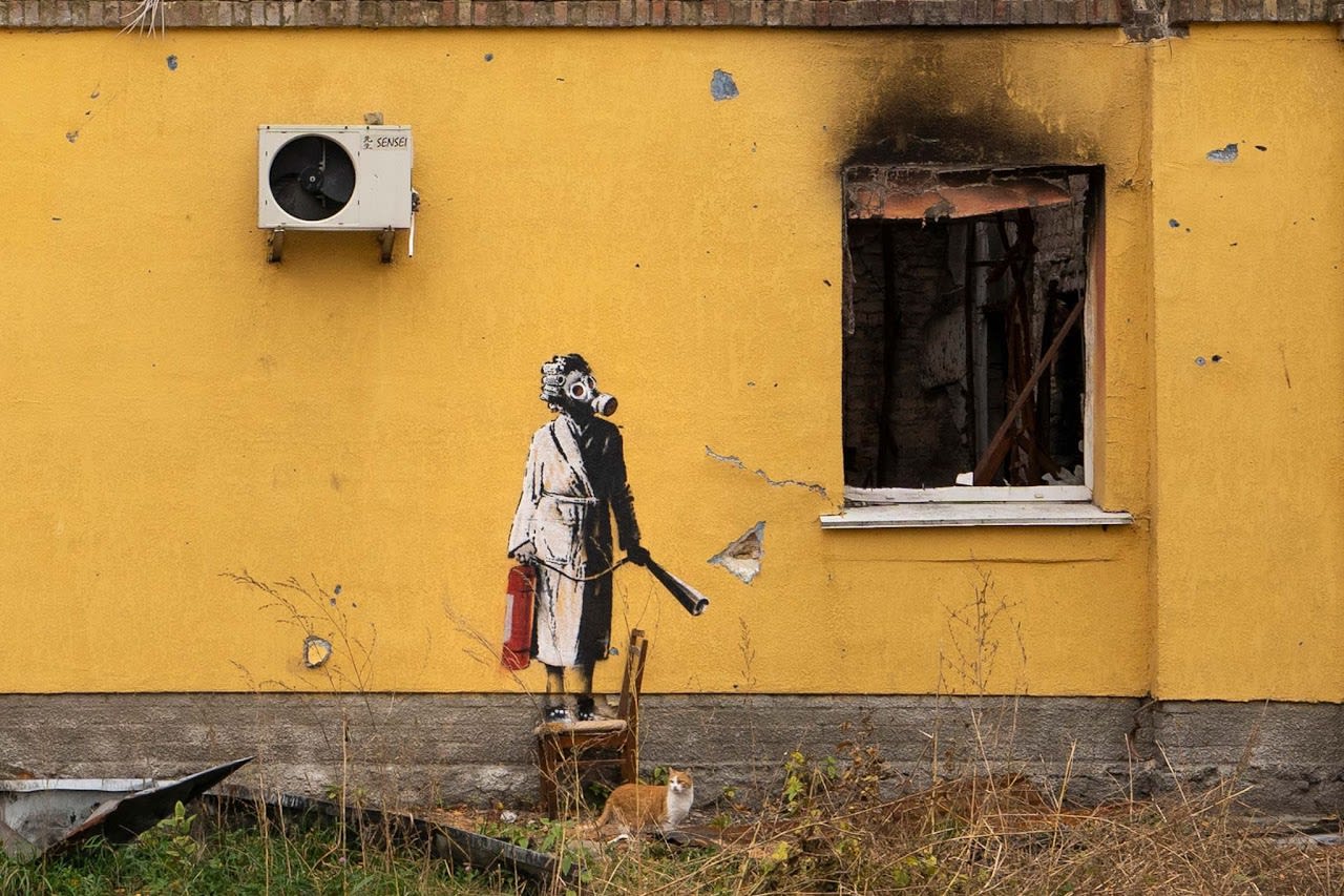 Banksy’s 2022 Woman with a Gas Mask mural in Hostomel fuses strength and satire in striking street art.