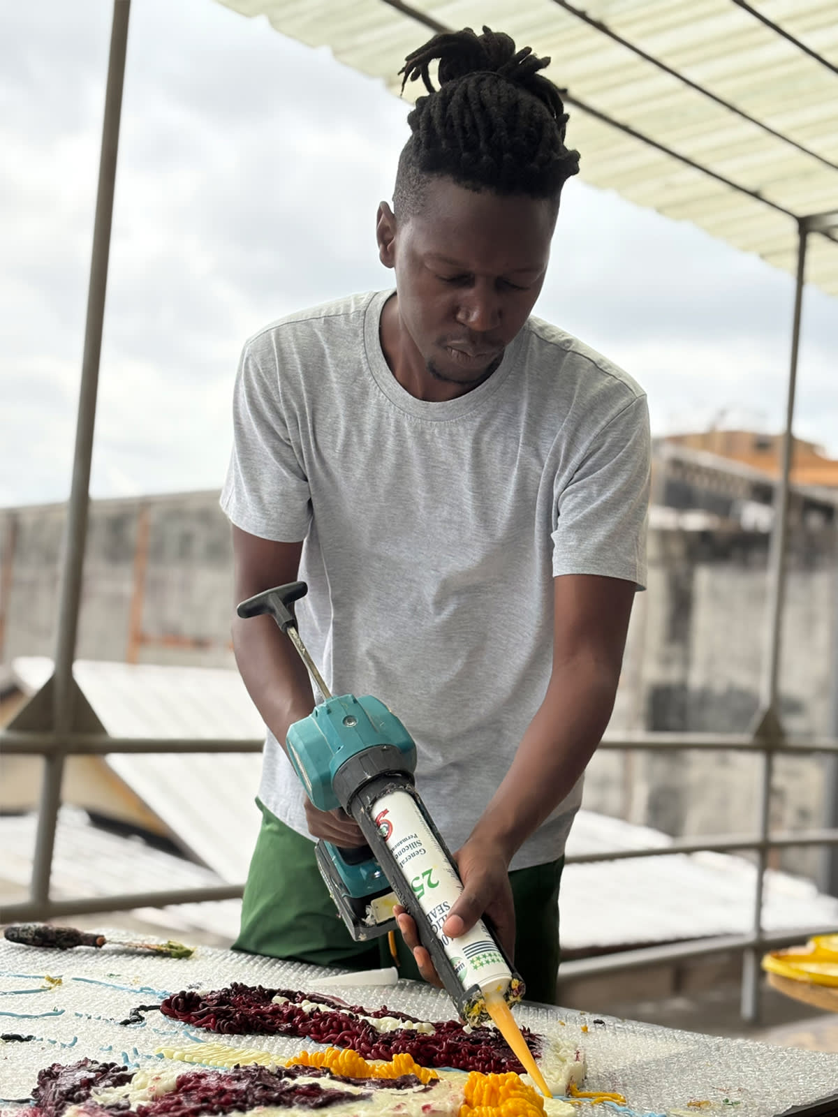 Troy Makaza working on a silicone piece at GALERIE FARAH FAKHRI's residency in Abidjan Ivory Coast