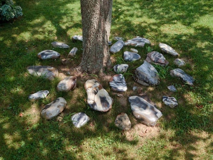 Aura Rosenberg Dialectical Porn Rock, Untitled, (Black/White Rock Circle #1), 1989/2012 rocks, newspaper, xerox, resin dimensions variable