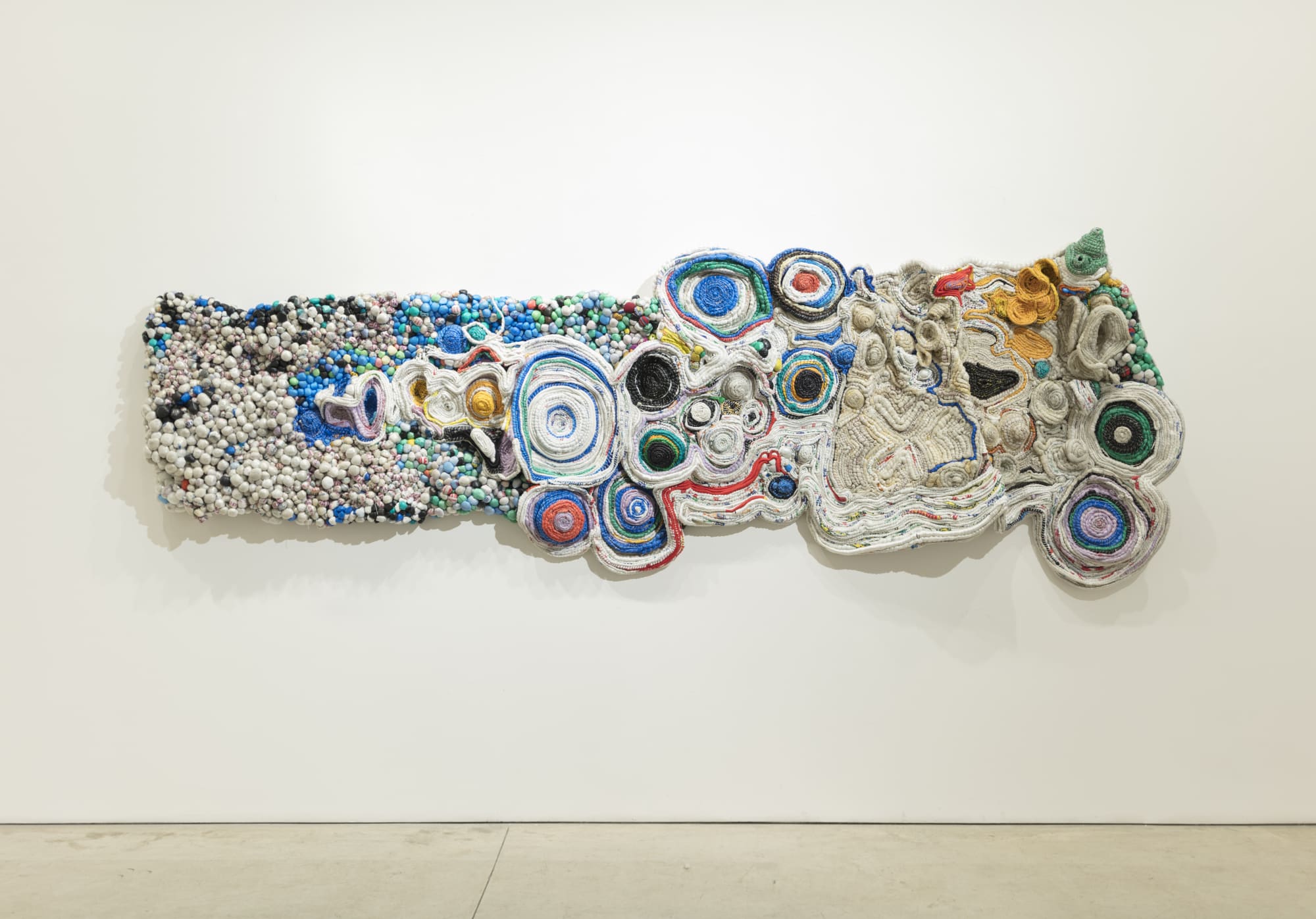 Ifeoma U. Anyaeji Eze Fuo eze anochie, (When a king leaves another replaces him – no condition is permanent) 2013 (edited 2015, 2019, 2021/2022) Plasto-yarning, Repurposed used non-biodegradable plastic bags (Plasto-yarns) bottles, wire mesh, twine, Bubblies 420 × 150 × 24 cm