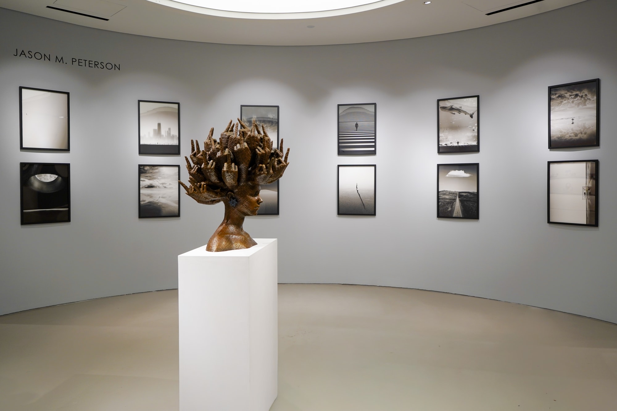 Triptych of Jason M. Peterson street scenes, luxury gallery setting.