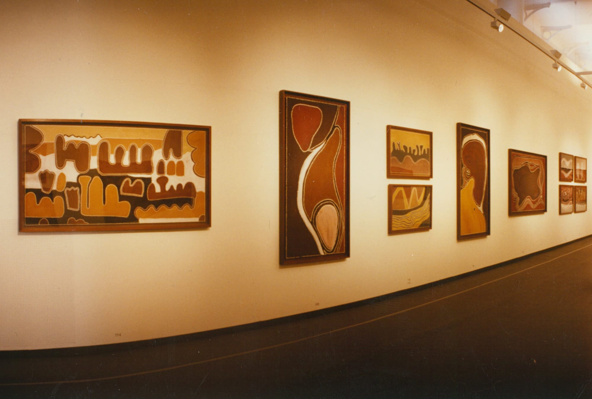 Main gallery space highlighting ochre masters such as Rover Thomas, grounding the exhibition in Country.