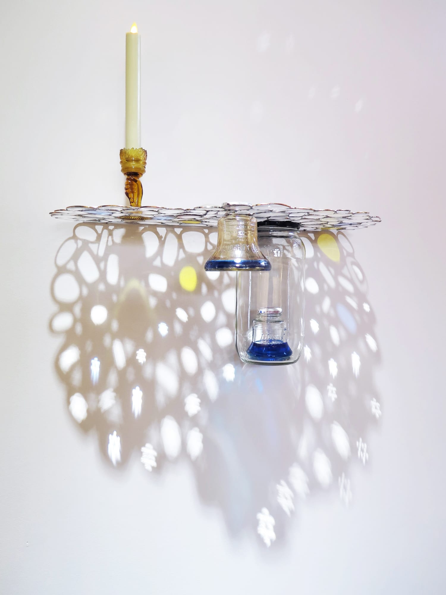 Liberty, 2022 Eyeglasses, sunglasses, found glass objects, LED candle, Blue Curacao, scotch whisky, stainless steel