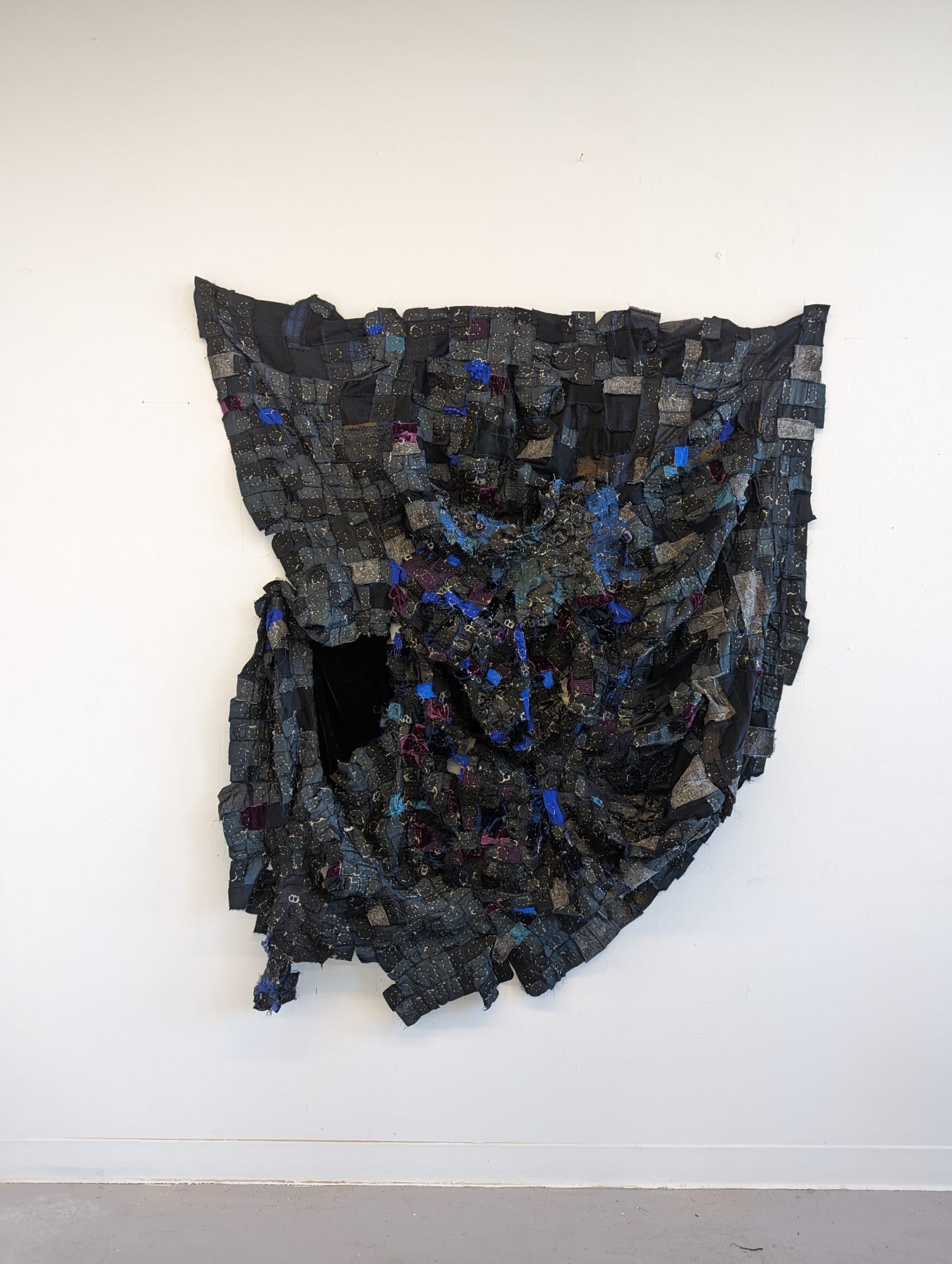 Madelaine Kobe The ceilings were blue like the sky. And they grew tall and they kept on growin’. The stars hid behind their shadows, 2023 Soda tabs, alpaca yarn, found fabric 72h x 60w in