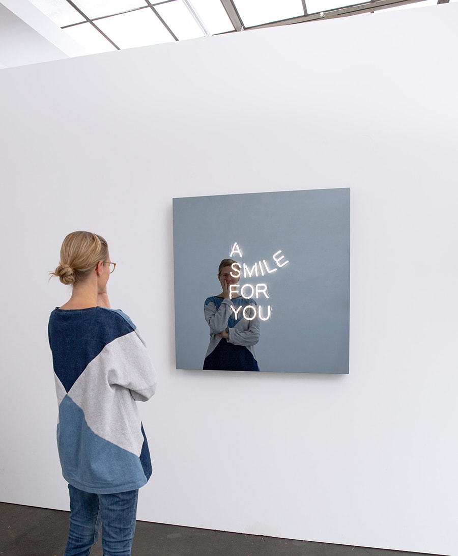 Jeppe Hein A Smile For You, 2018 Powder-coated aluminium, blue neon tubes, two-way mirror, powder-coated steel, transformers 100 x 100 x 10 cm