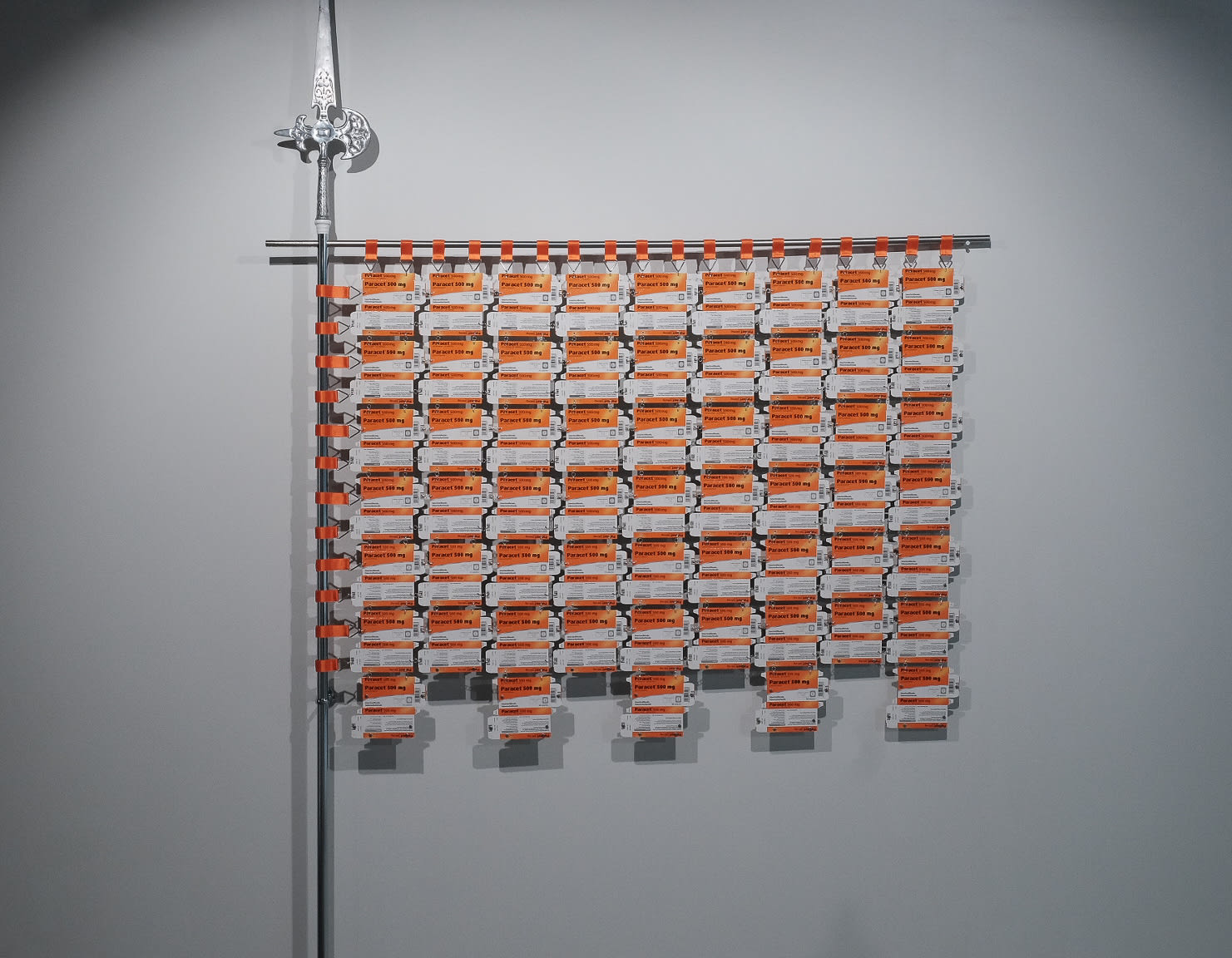 «Banner of Pain Relief», 2024 270x160cm, aluminum, silver, steel, cotton, 59 Paracet boxes