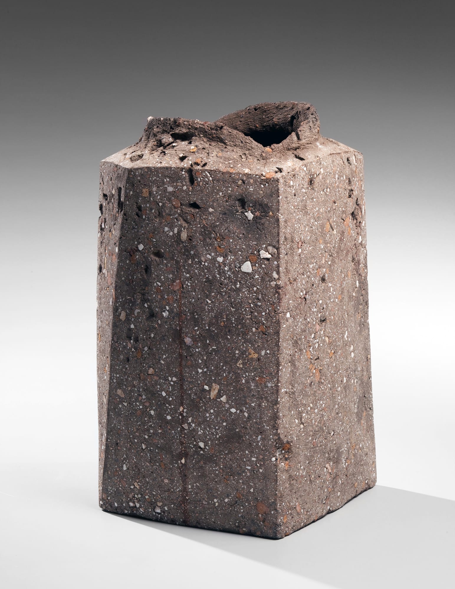Itō Sekisui V (b. 1941) Standing four-sided rough grey vessel with raised torn mouth 2012 Unglazed stoneware with crushed embedded stones and iron-oxide clay 14 x 8 1/2 x 8 1/2 inches SOLD