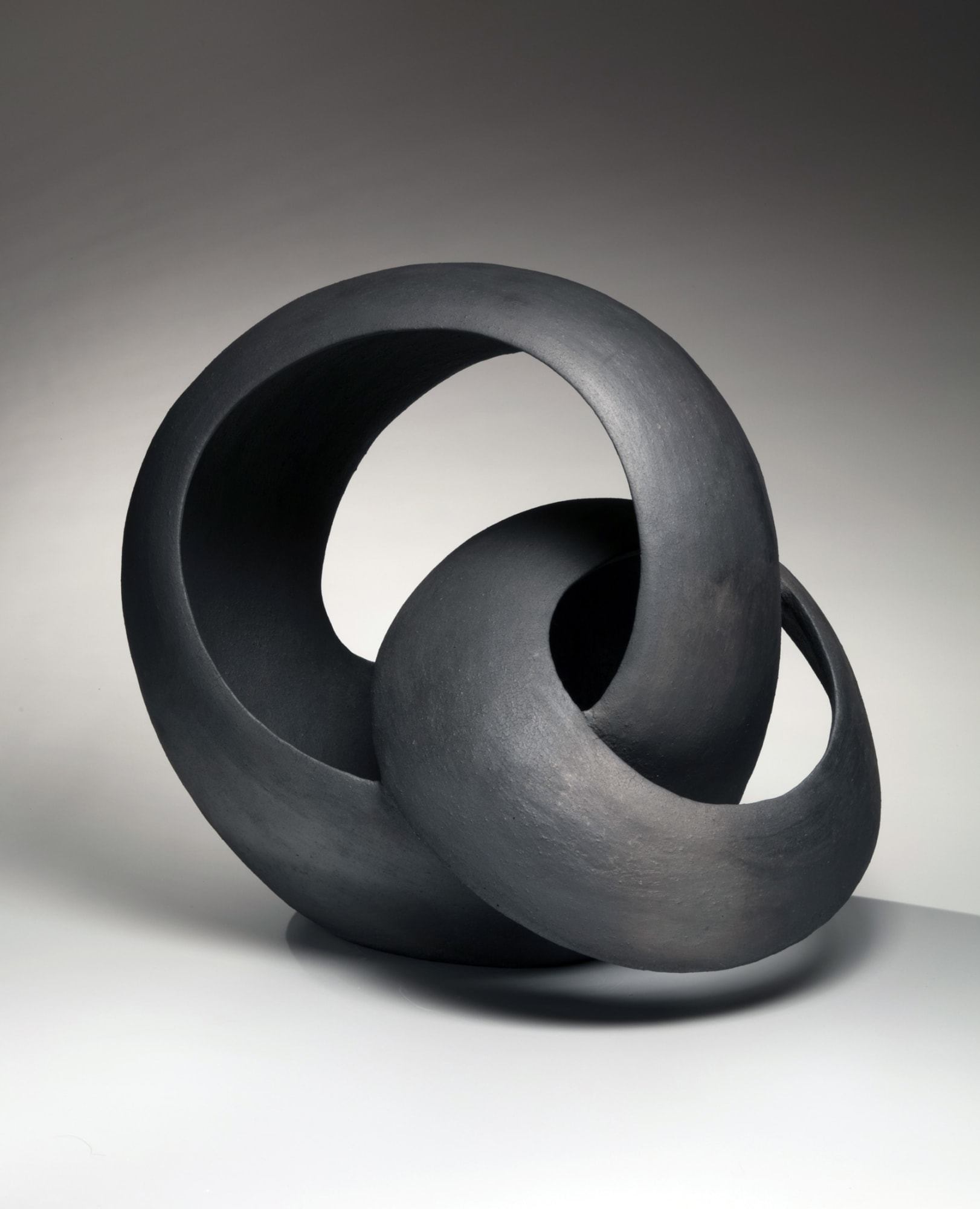 Kurokawa Tōru (b. 1984) Black sculpture of two interlaced loops 2018 Smoke-infused stoneware 17 x 16 x 12 inches SOLD