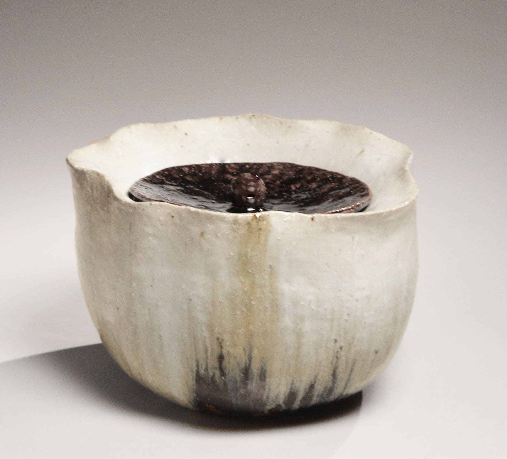NISHIHATA TADASHI (b. 1948) Water jar with foliated rim, recessed mouth and matching cover with knob handle, all covered with Tamba ash glaze 2019 Tamba ash-glazed stoneware 6 1/2 x 10 1/2 x 8 7/8 in. Inv# 11262