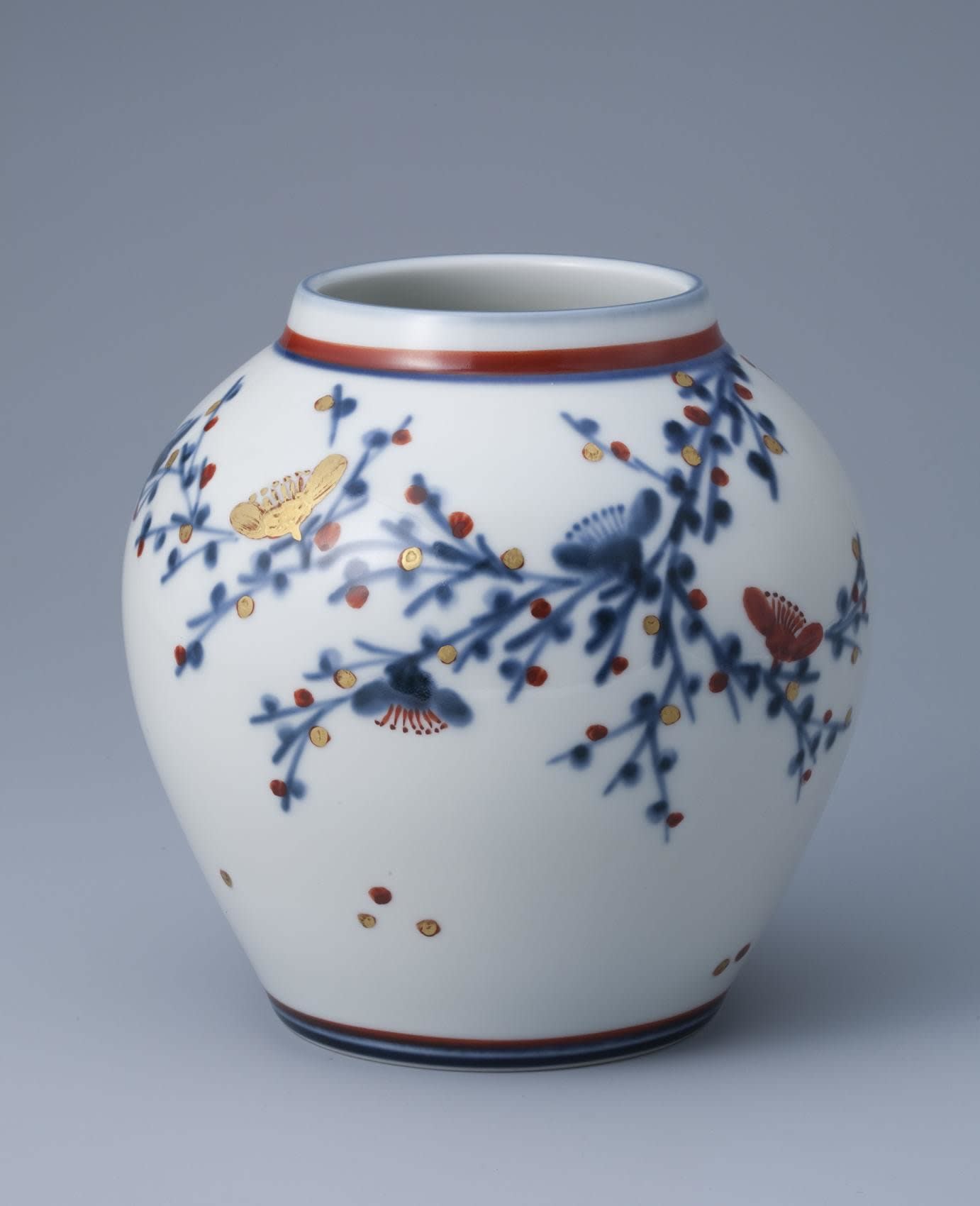 Kondô Hiroshi (b. 1936) Glazed white porcelain vase with plum blossom decoration in blue, gold and red enamel glazes, 2009 Glazed porcelain with blue, gold and red glazes 8 1/4 x 7 7/8inches Inv# 6720 SOLD