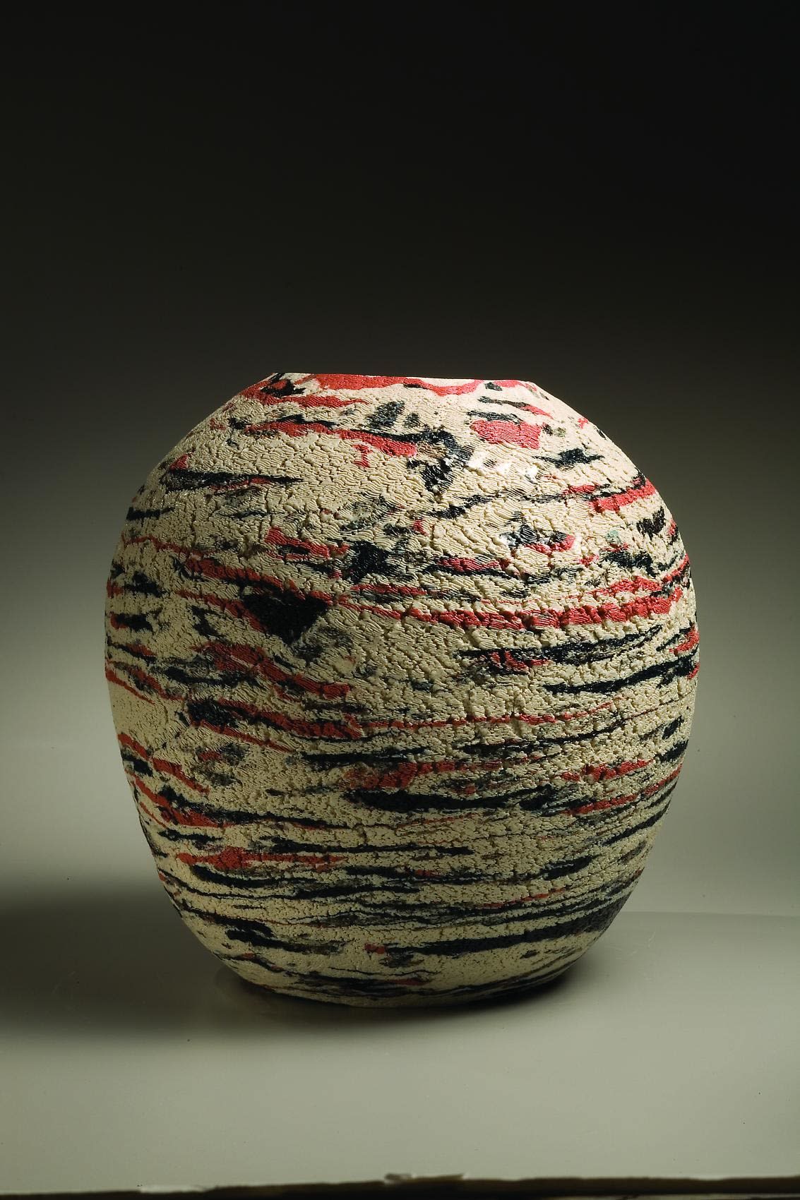 Matsui Kôsei (1927-2003) Neriage vessel with inlays of black, white and red clays and sand treated surface , 1985 Stoneware with marbleized colored clay inlays 12 5/8 x 12 1/5 inches Inv# 5696 SOLD