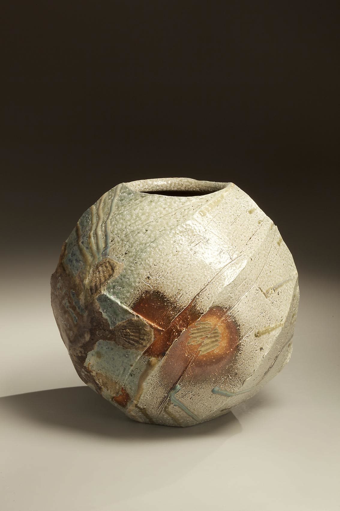 Spherical Tanba vessel with faceted diagonal banding and dripping natural ash glaze and markings from impressed shells, 2011 Wood-fired stoneware with natural ash glaze 13 1/2 x 14 1/2 inches; Inv# 6888 SOLD