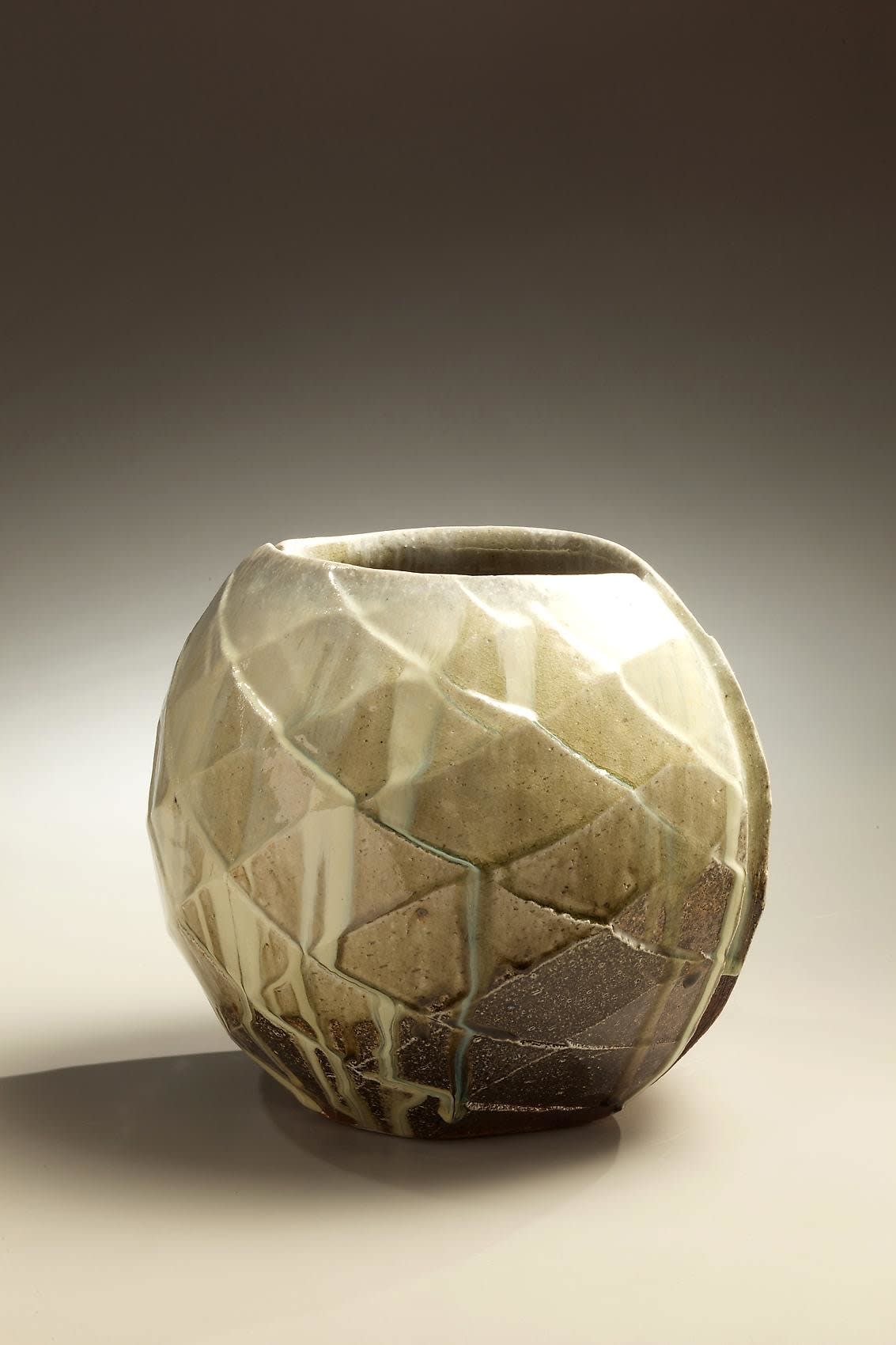 Wide mouthed spherical Tanba vessel with diamond-shaped carved surface patterning and ladle-poured ash glaze, 2010 Wood-fired stoneware with ash glaze 10 1/4 x 12 1/4 x 10 5/8 inches; Inv# 6891 SOLD