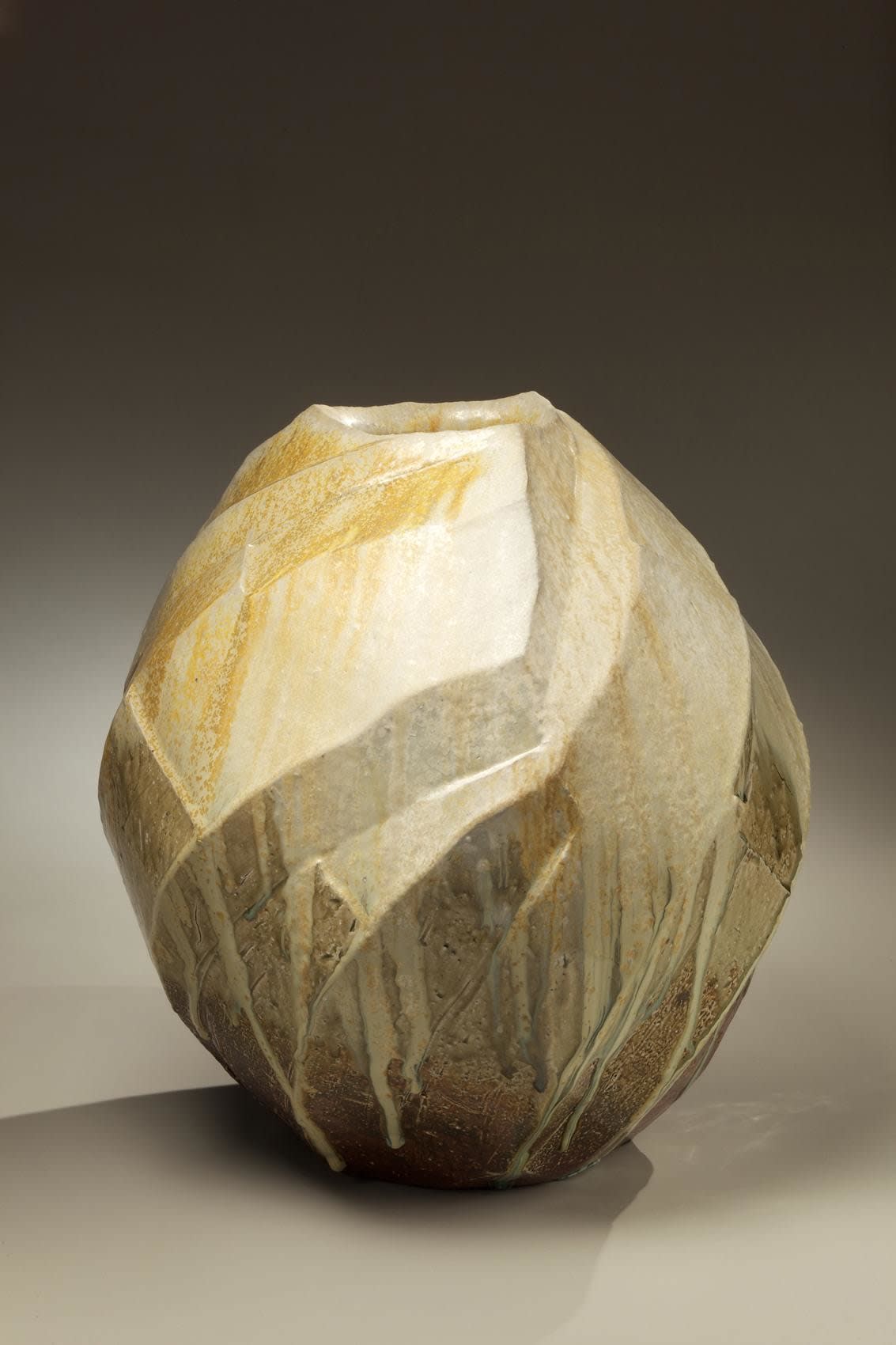 Thickly walled three-sided Tanba vessel with diagonal carved bands and covered in thick dripping ash glaze, 2011 Stoneware with natural ash glaze 16 1/8 x 15 3/4 inches; Inv# 6921 SOLD