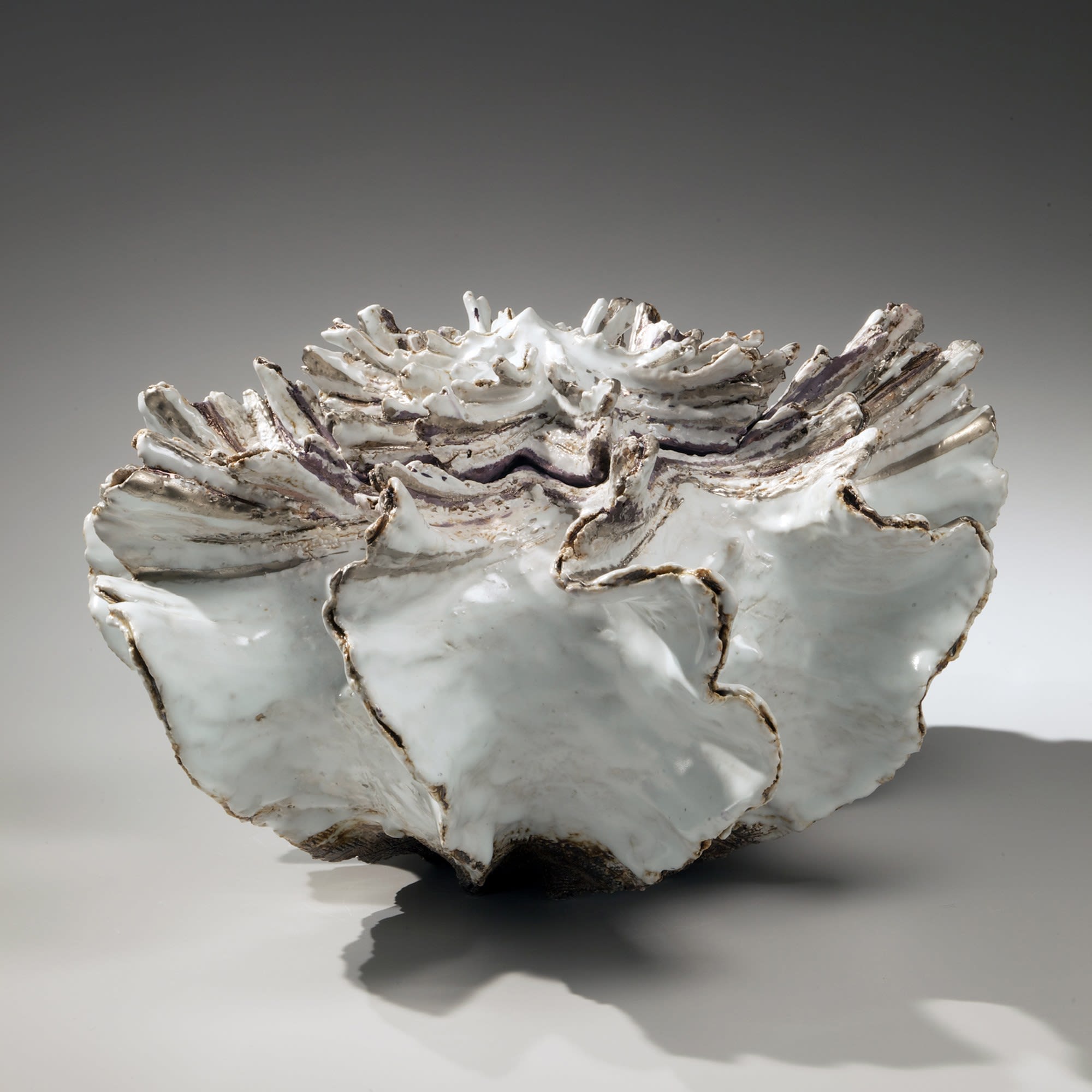 Low pleated shell-shaped covered vessel with streaked top, silver glaze along the flaring edges, white-glazed interior and purple-glazed interior rim 2011 Glazed stoneware with silver glaze 10 5/8 x 16 1/8 x 16 1/8 in. Inv# 8178