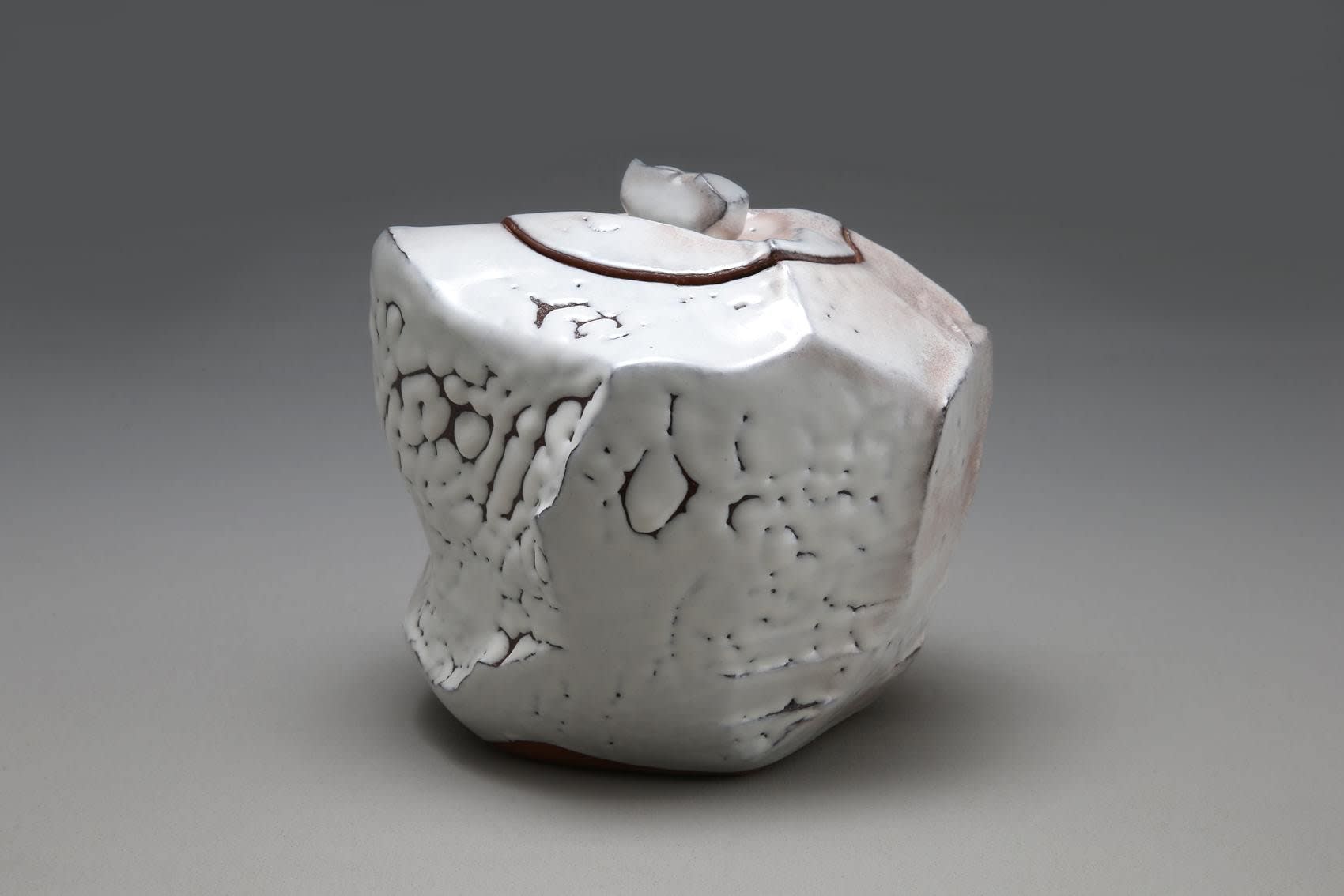 Sculpted covered waterjar with faceted sides, covered with crawling Hagi white glaze (kairagi) with pink tones, and kiln effects, 2013 Glazed stoneware 8 1/8 x 9 1/4 x 8 3/4 in. Inv# 9045