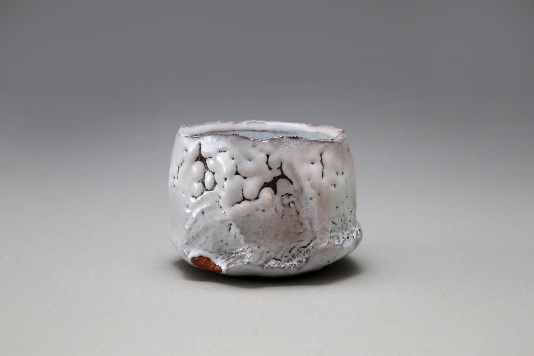Straight walled teabowl with jagged rim, kairagi, or crawling, Hagi white glaze, and kiln effects, 2014 Glazed stoneware 3 5/8 x 4 7/8 x 4 5/8 in. Inv# 9050