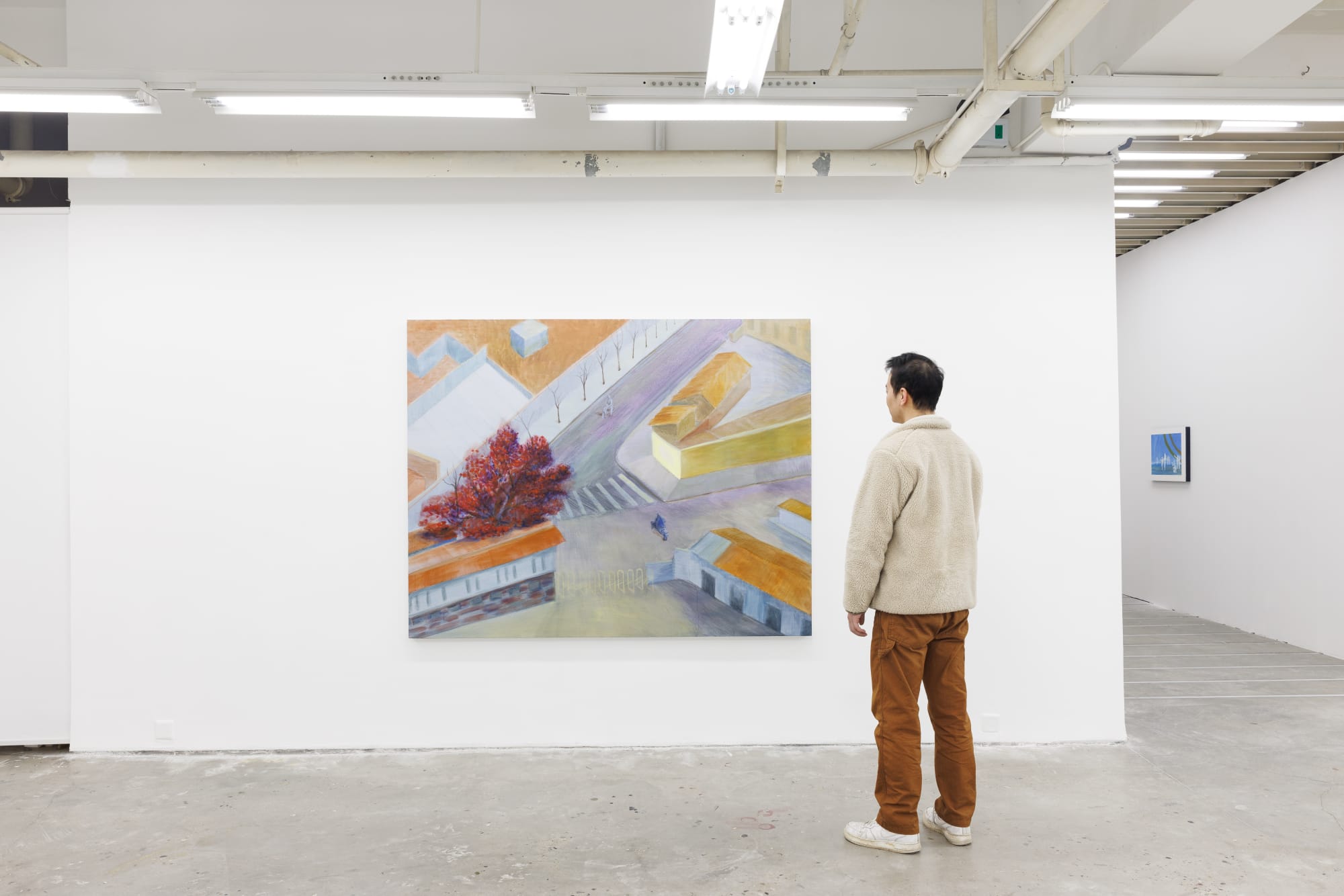 Installation view of Anna Ngan Leong Cheung's work Pengcheng Corner VX created in 2025; a male visitor stands in front of it.