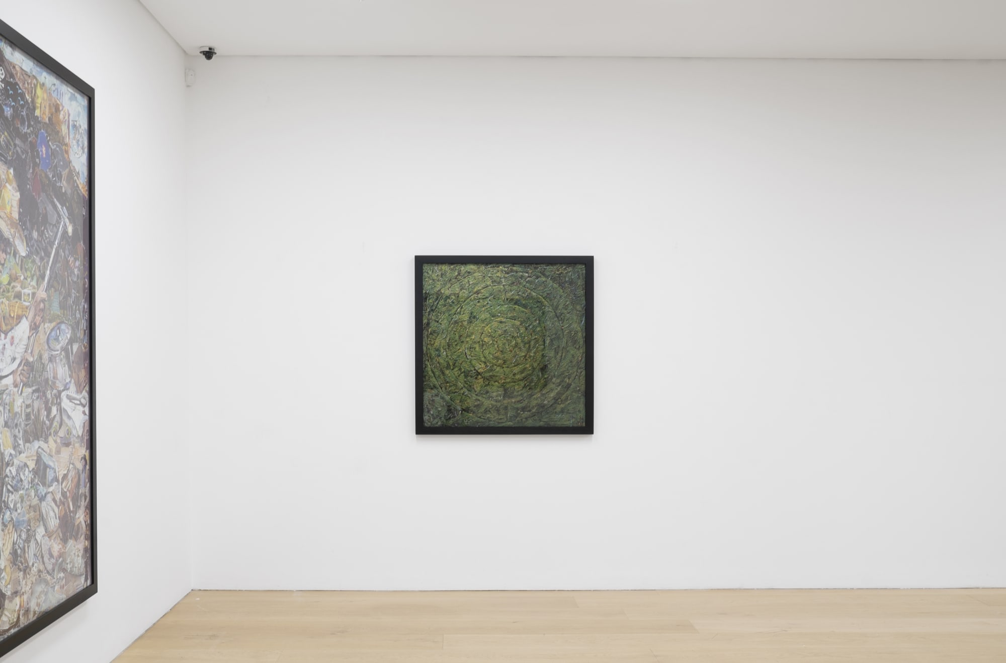 Installation view of a gallery with framed photo collages by Vik Muniz