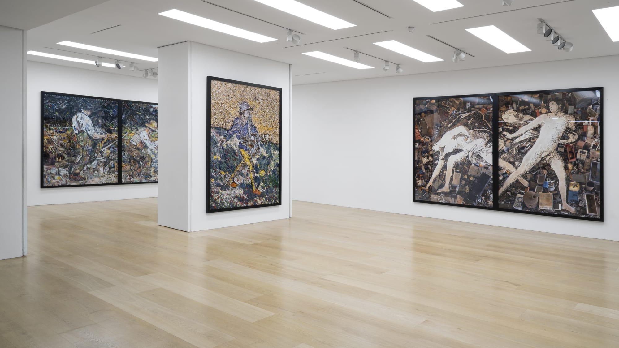 Installation view of a gallery with framed photo collages by Vik Muniz