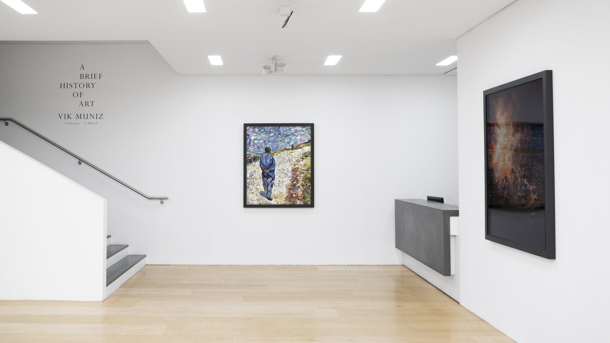 Installation view of a gallery with framed photo collages by Vik Muniz