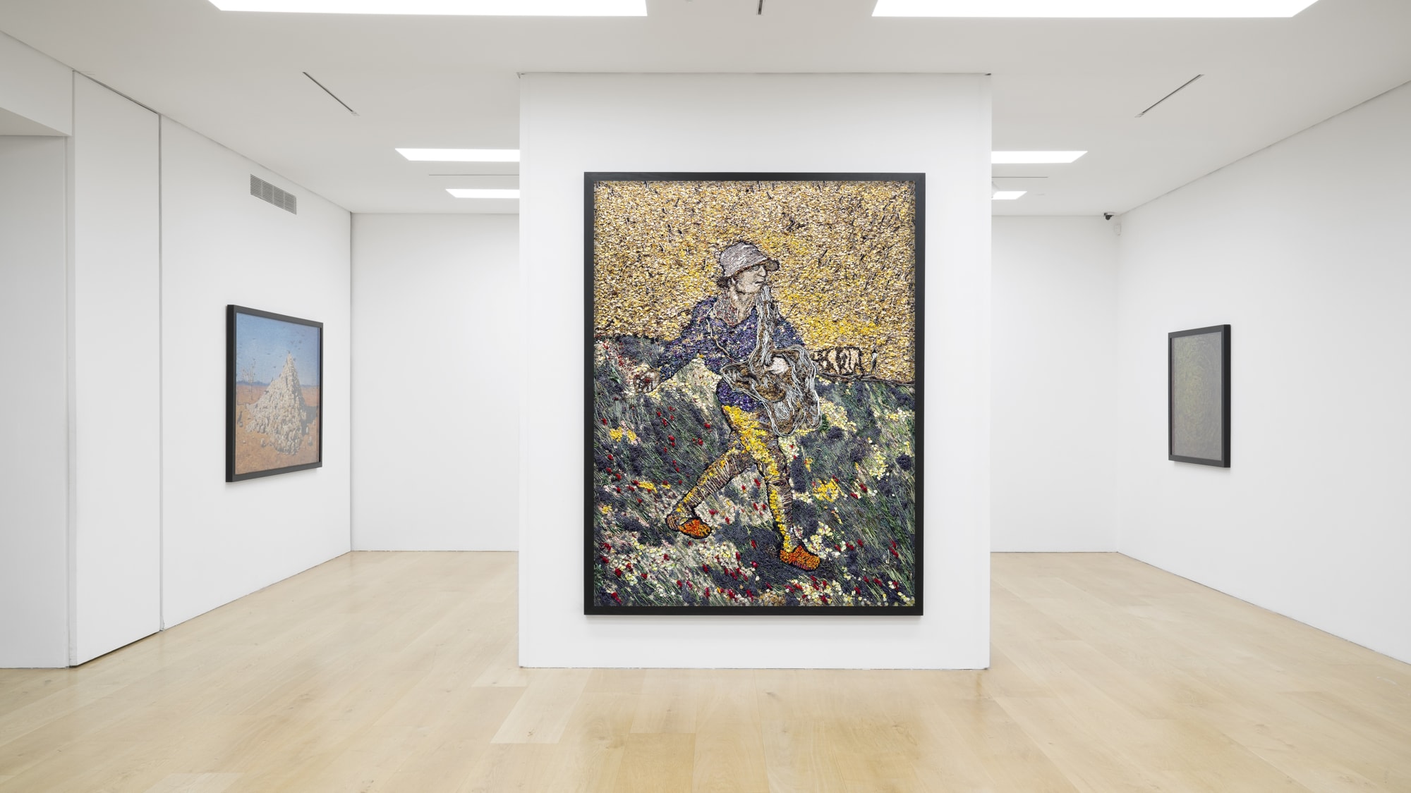 Installation view of a gallery with framed photo collages by Vik Muniz