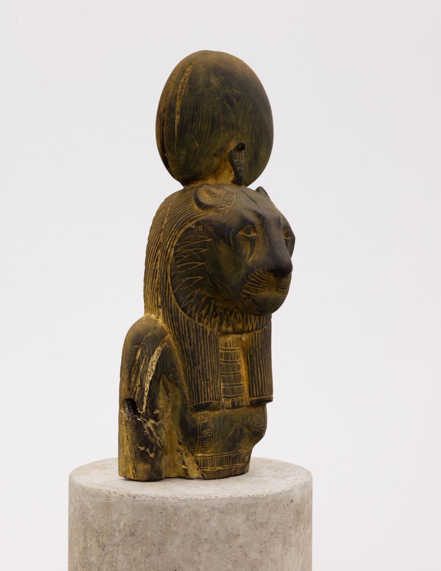 Sculpture of Sekhmet from Egypt; early 20th century; wood with patina on custom cement base; unique; 20.8” high x 7.8” wide (figure).