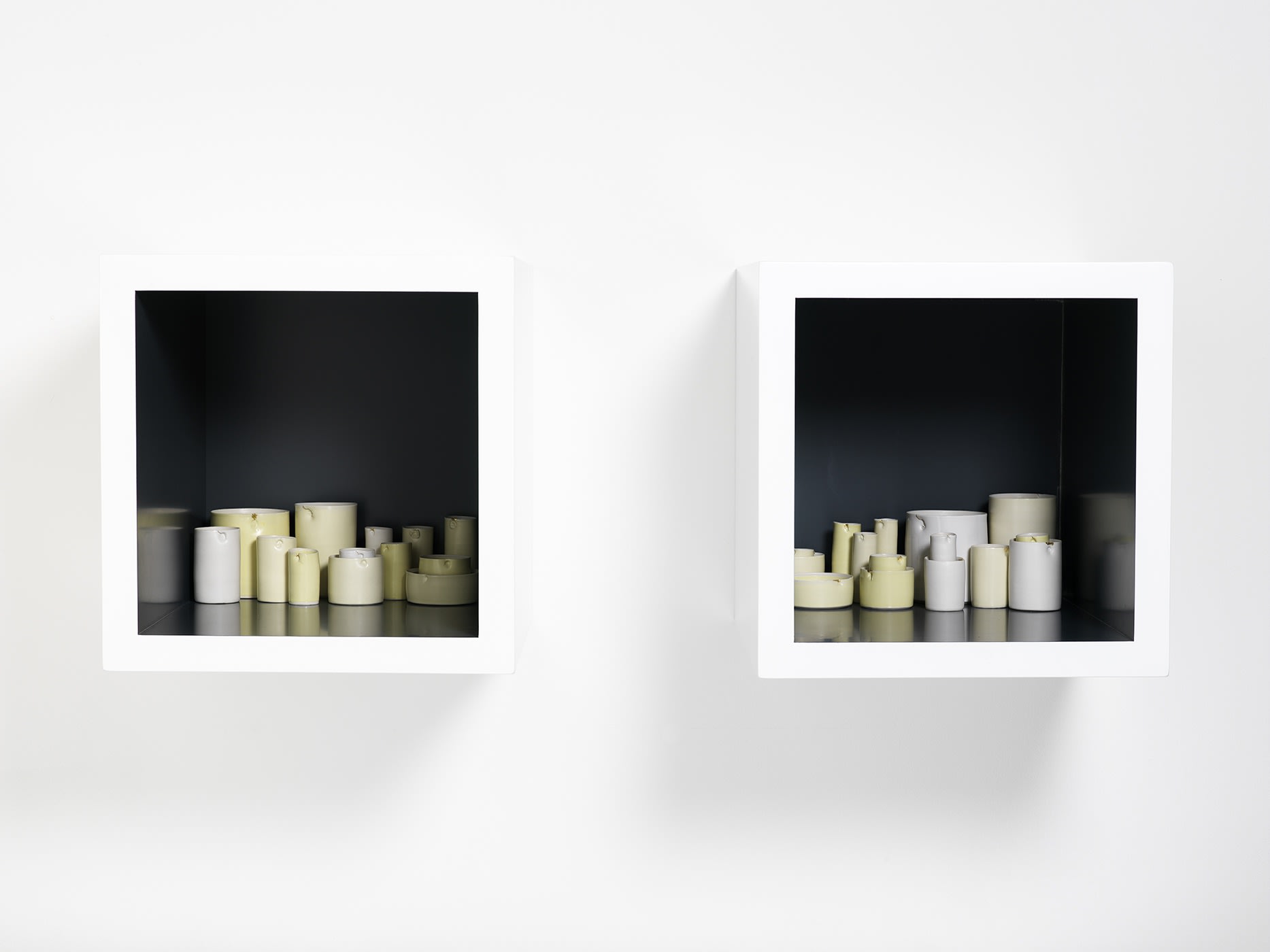 Edmund DE WAAL (b.1964) Aurea, 2007 Two lacquer cabinets containing 28 thrown porcelain vessels in white and yellow glazes with gold leaf Cabinets each 13 ¾ x 13 ¾ x 17 ¾ inches / 35 x 35 x 45 cm